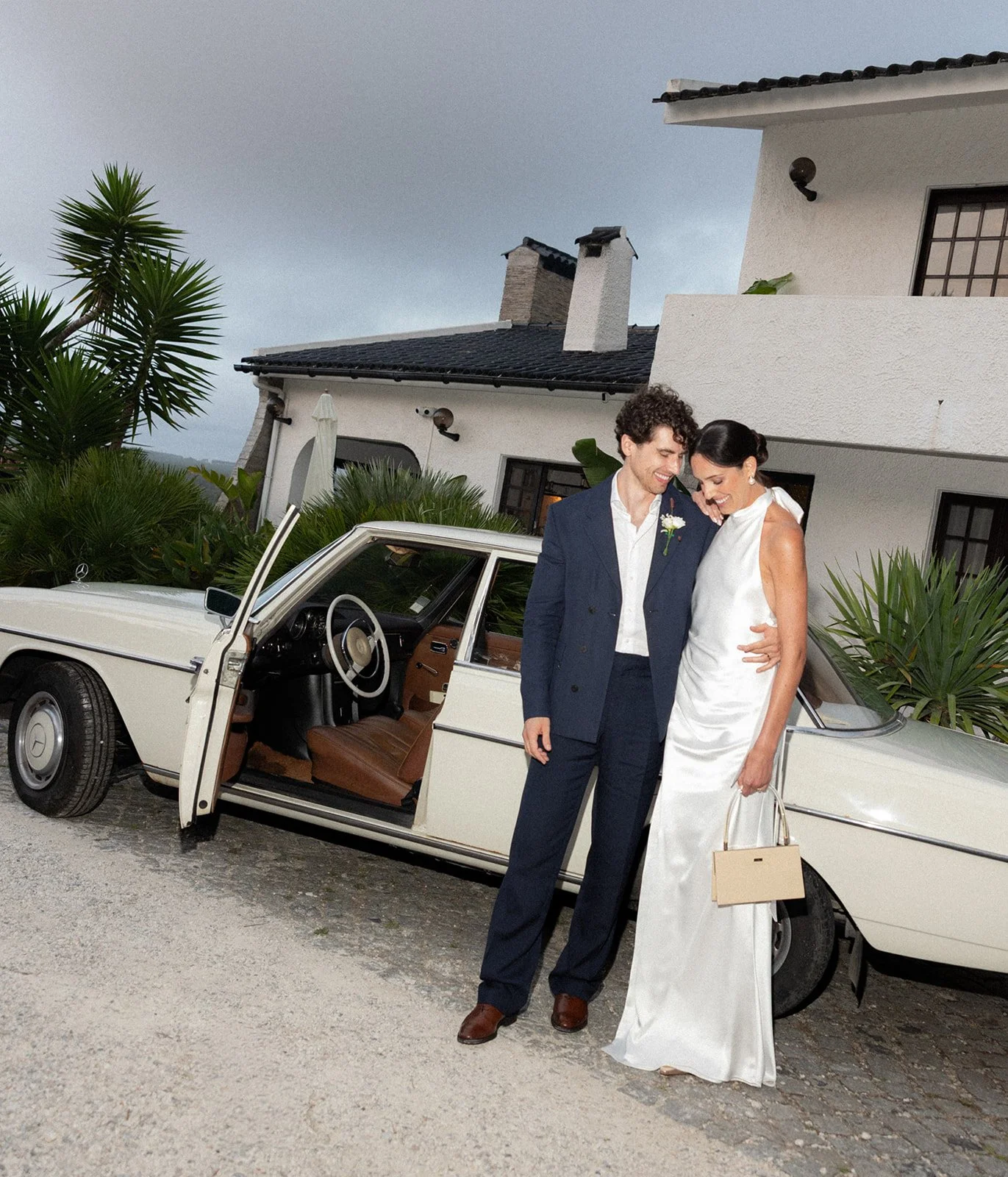 Couple laughing beside a vintage car, Sintra Portugal | wedding photography by The Lopes Photography