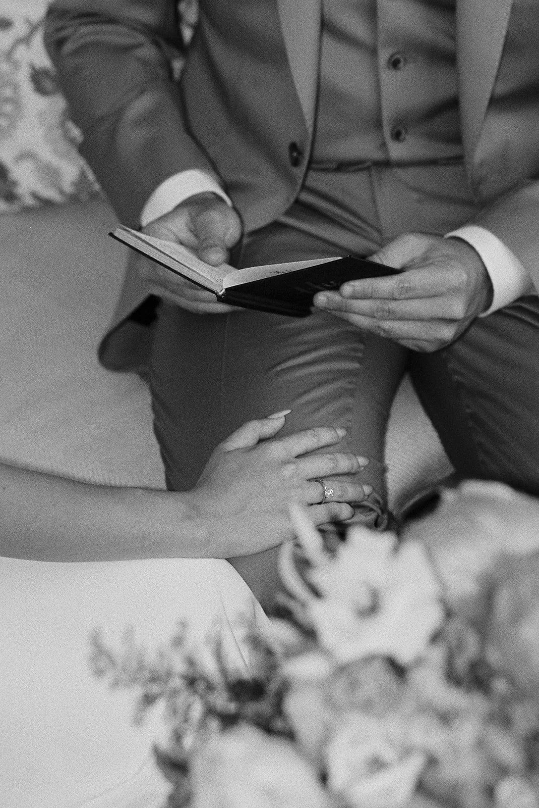Couple's hands holding a vow booklet, Belmond Grand Hotel Timeo, wedding photography by The Lopes Photography