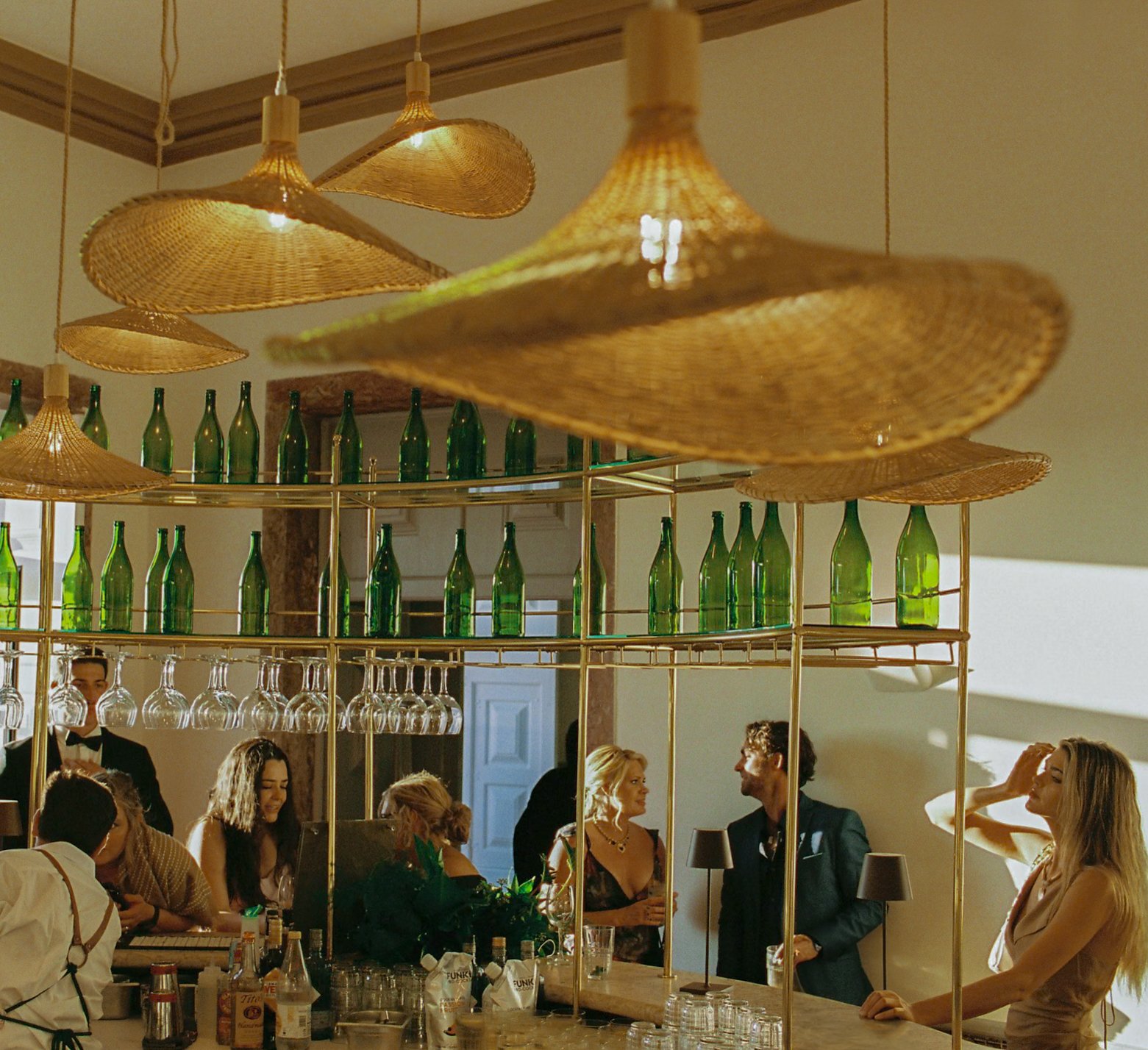 Guests enjoying cocktail hour at a destination wedding in Portugal, with relaxed movement, shaded seating, and natural atmosphere after the ceremony.