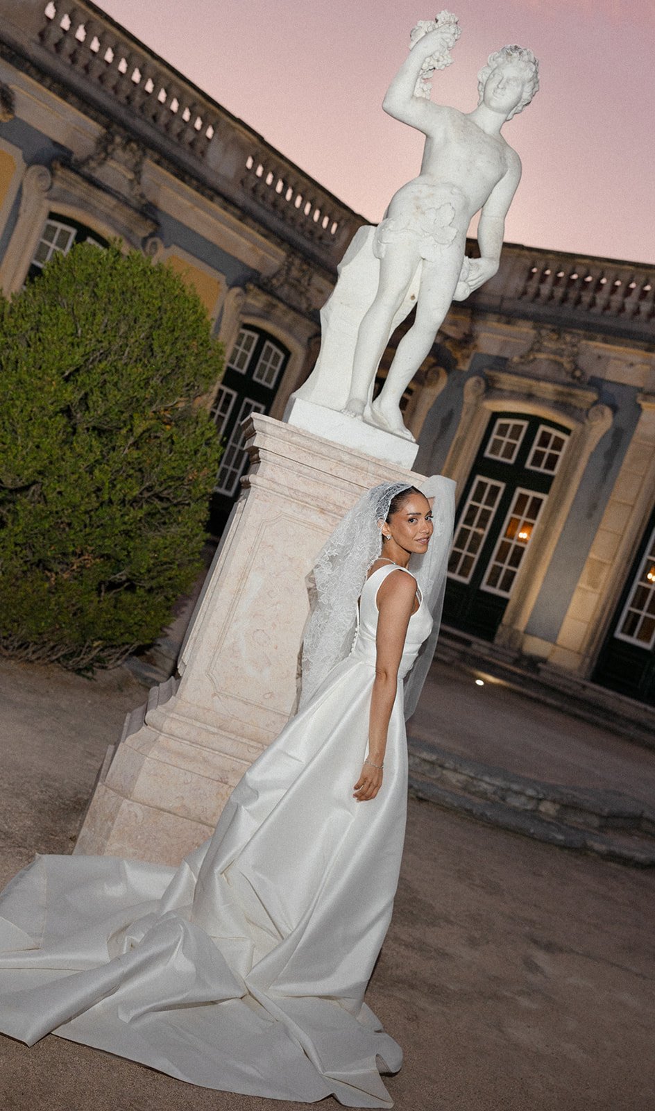 Bride photographed at dusk in the gardens of Palácio de Queluz by The Lopes Photography