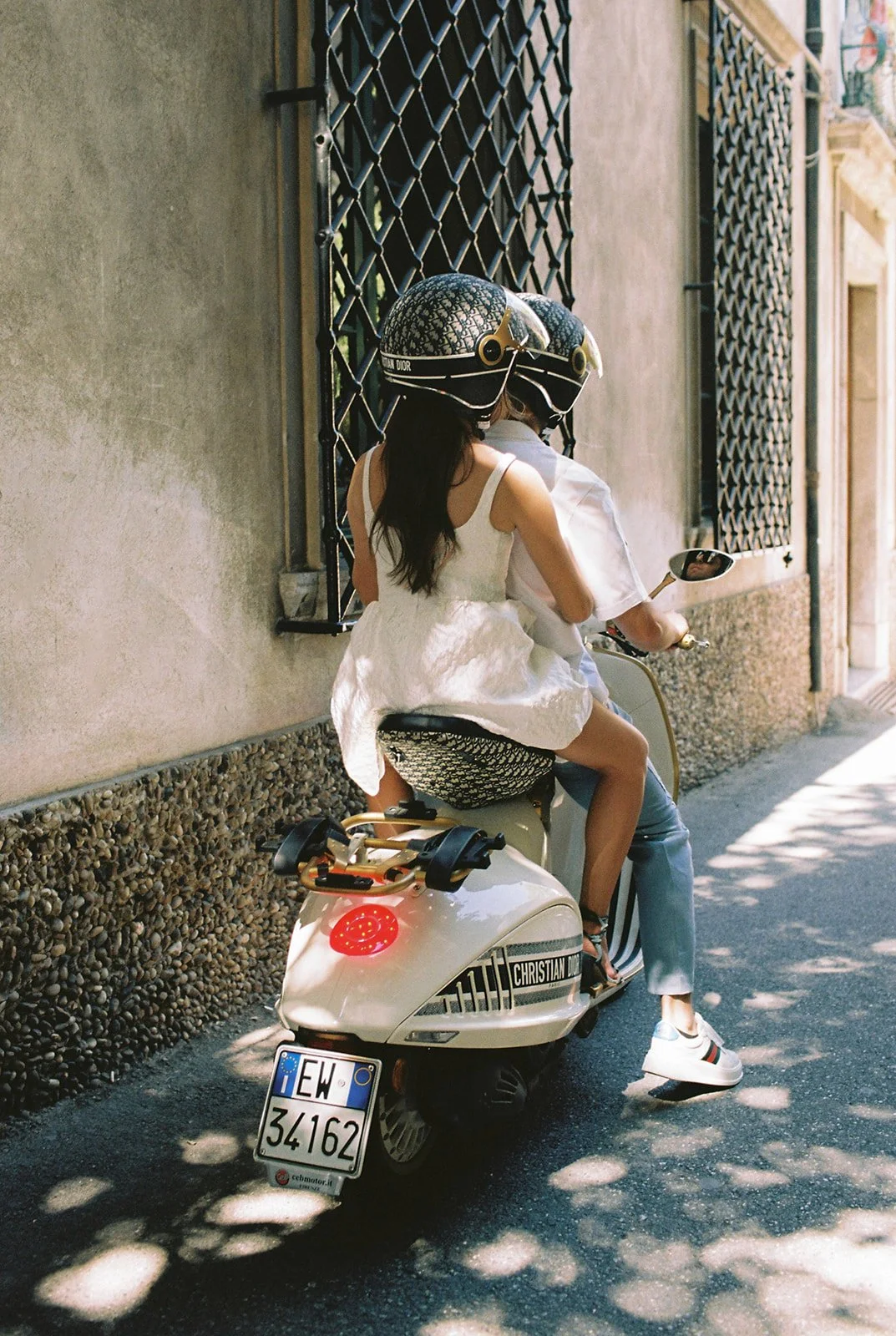 Bride and groom riding a Christian Dior Vespa through the streets of Taormina on their wedding day | The Lopes Photography
