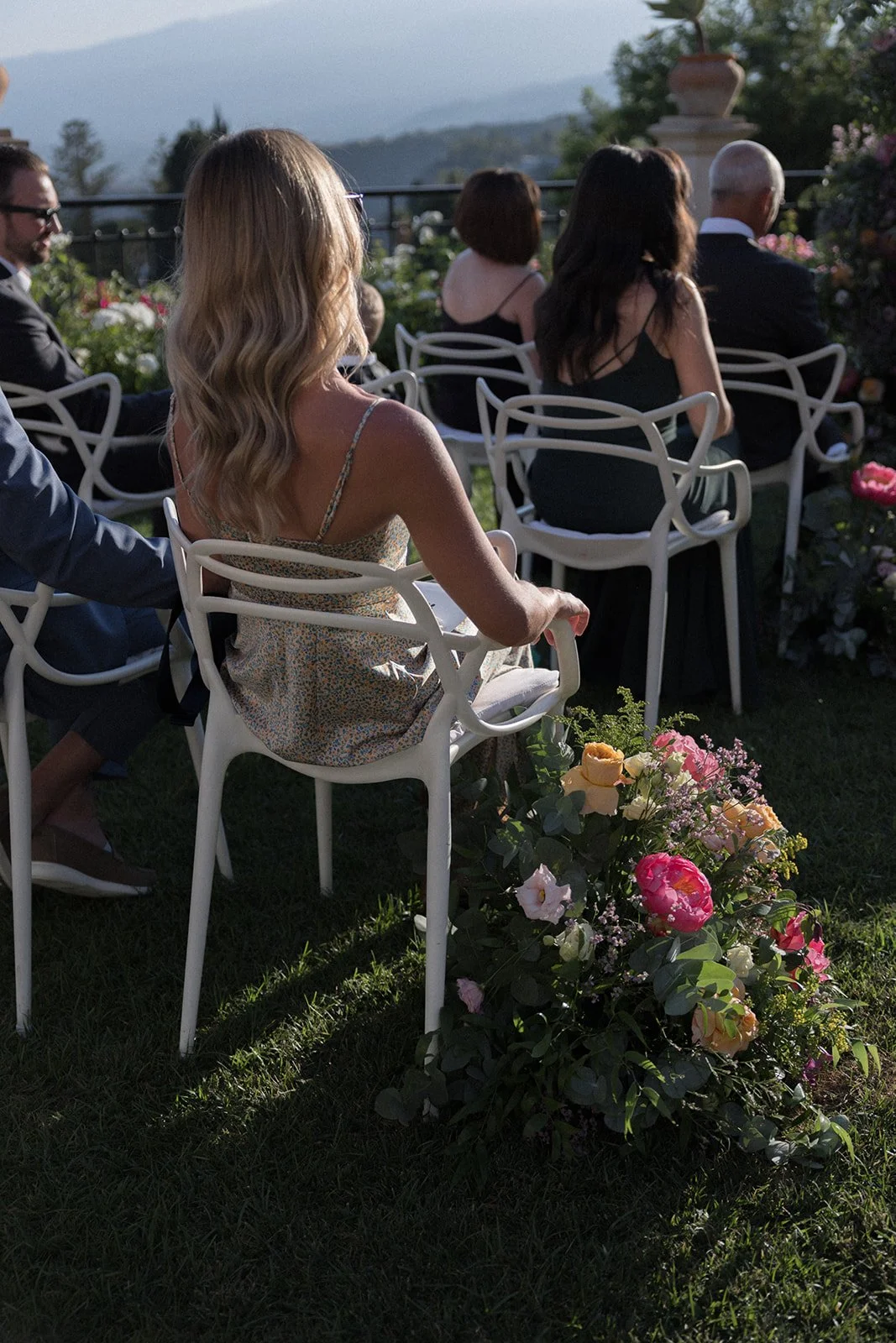 Guests on white chairs beside a rose-lined aisle, Belmond Grand Hotel Timeo, wedding photography by The Lopes Photography
