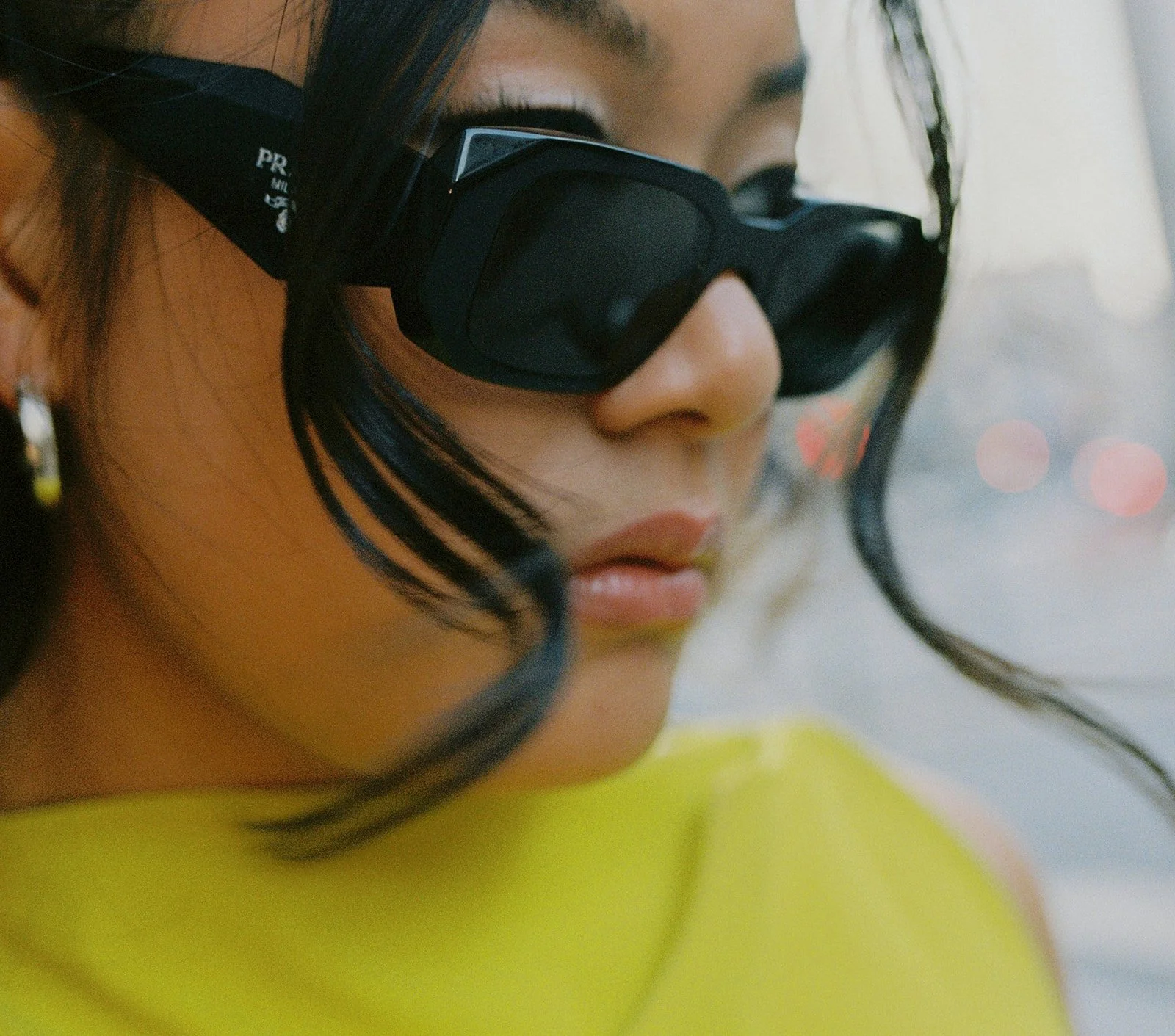 Film photo of an American-Chinese bride as an artistic close-up portrait and she is wearing black Prada sunglasses