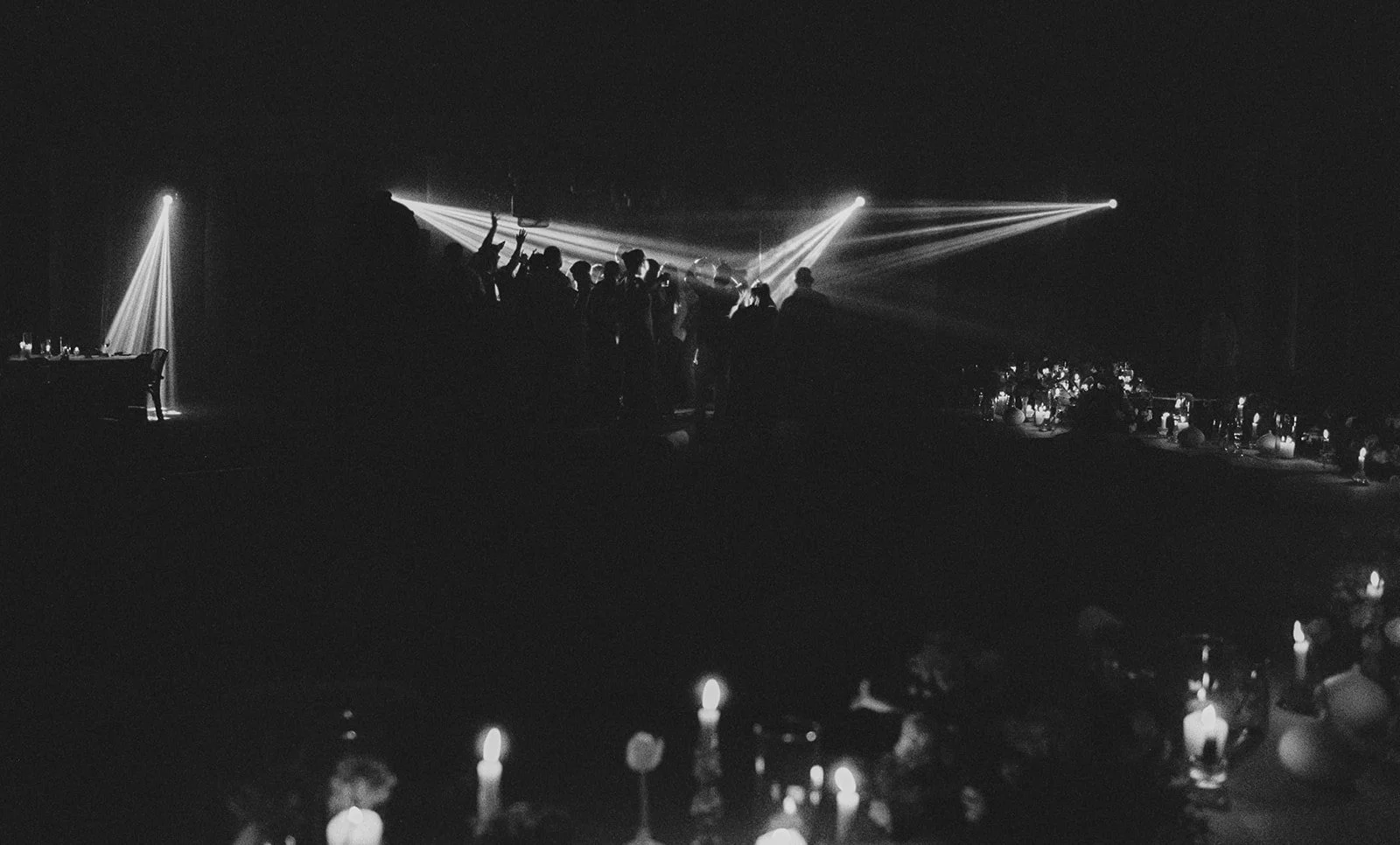 Guests silhouetted by beam lighting at night, Mosteiro de Landim, destination wedding photography by The Lopes Photography