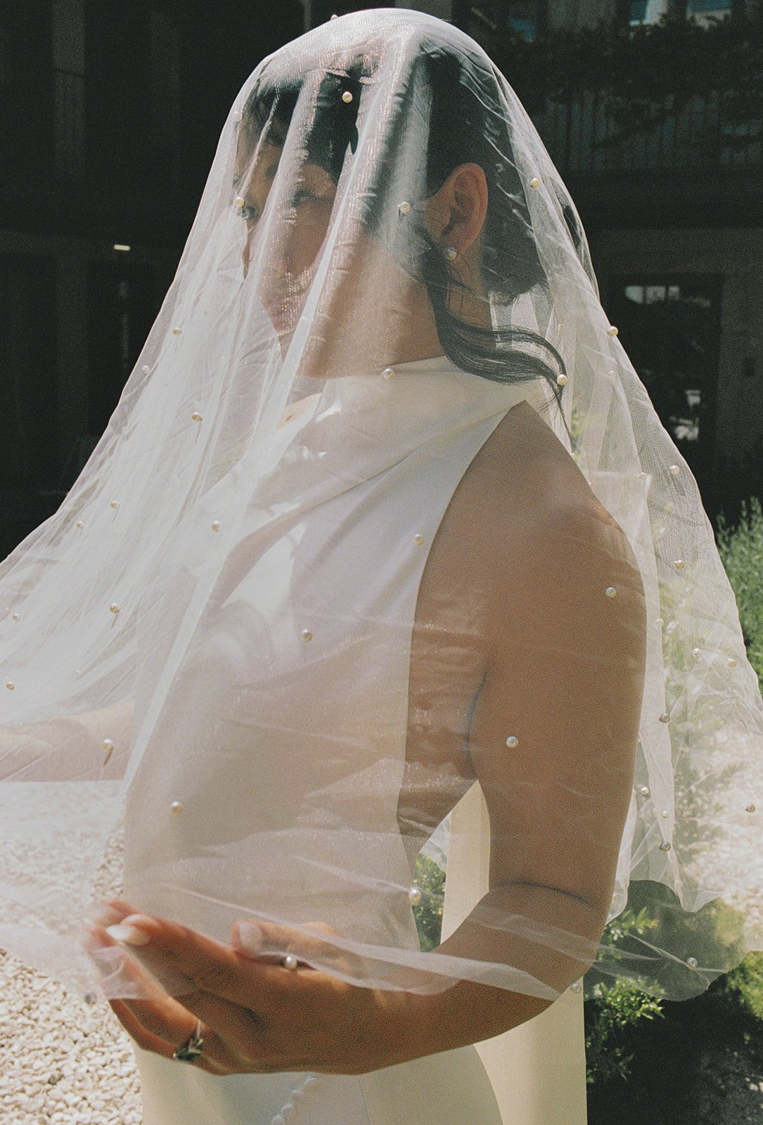 Bride in cream strapless gown with pearl veil on garden path, Mosteiro de Landim, wedding photography by The Lopes Photography