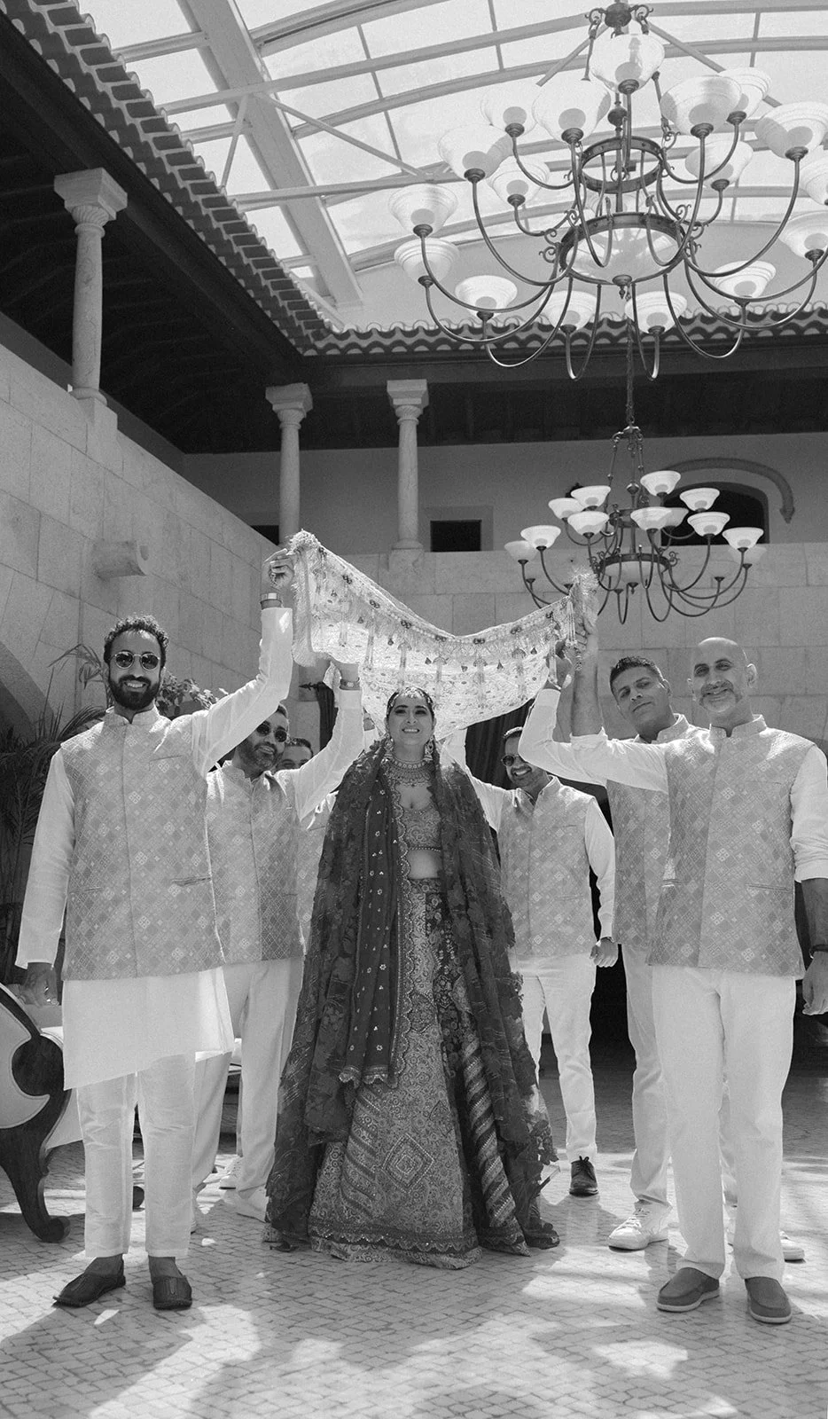 Bride in patterned lehenga during a traditional ceremony at Fortaleza do Guincho, destination wedding in Portugal | by The Lopes Photography