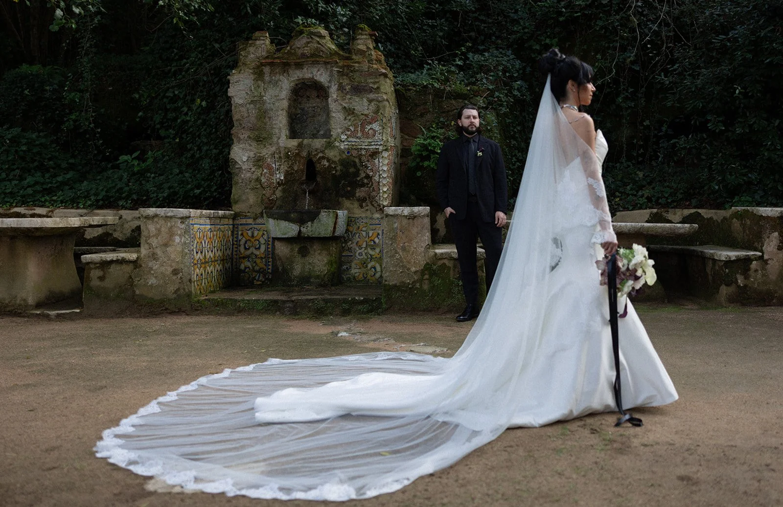 Couple portrait by azulejo fountain at Convento dos Capuchos, Sintra, editorial wedding photography by The Lopes Photography