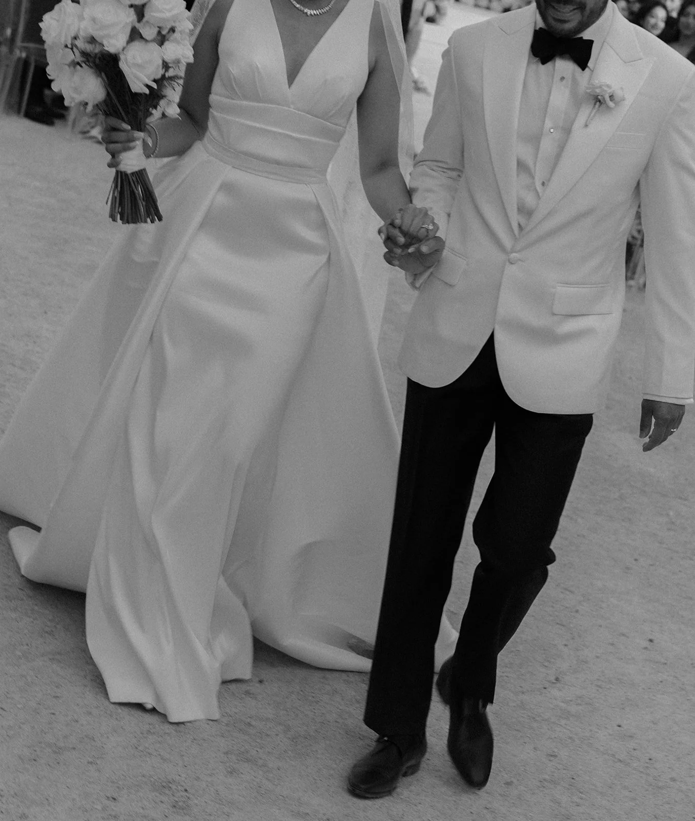 Newlyweds walking hand in hand, Palácio de Queluz garden, black and white film, editorial photography by The Lopes Photography