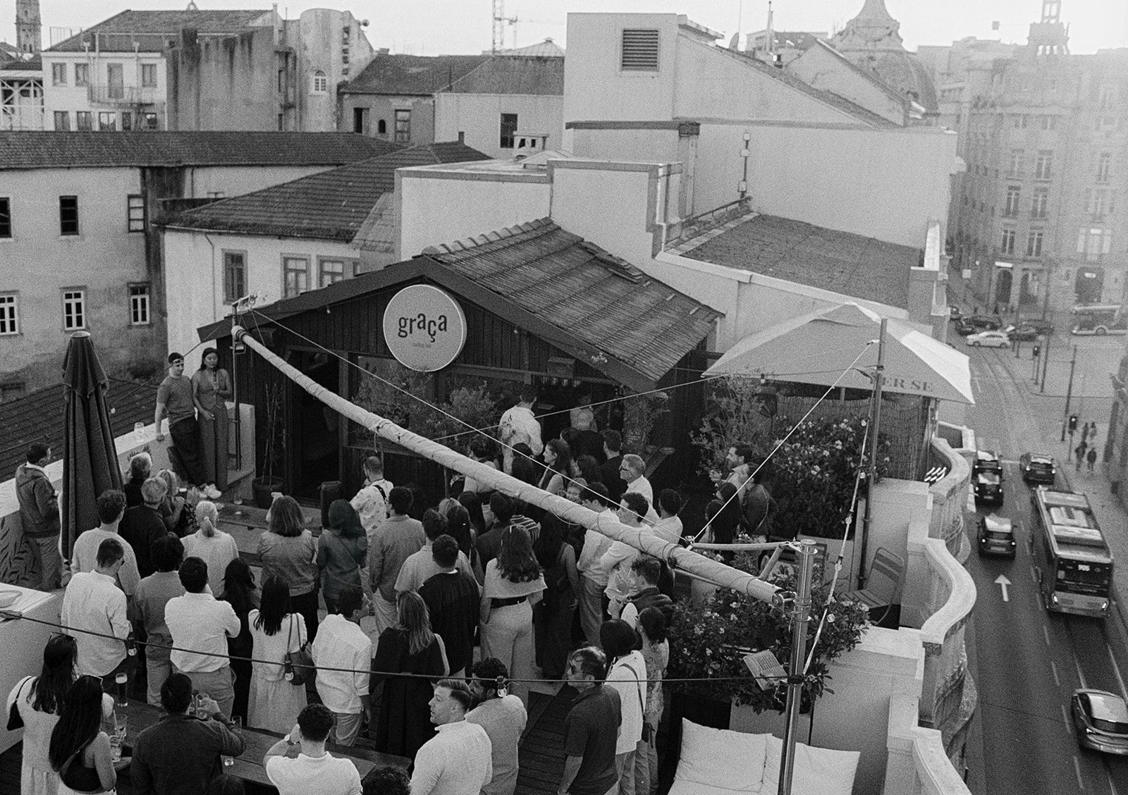 Guests on a Porto rooftop terrace with period architecture, destination wedding in Porto by The Lopes Photography