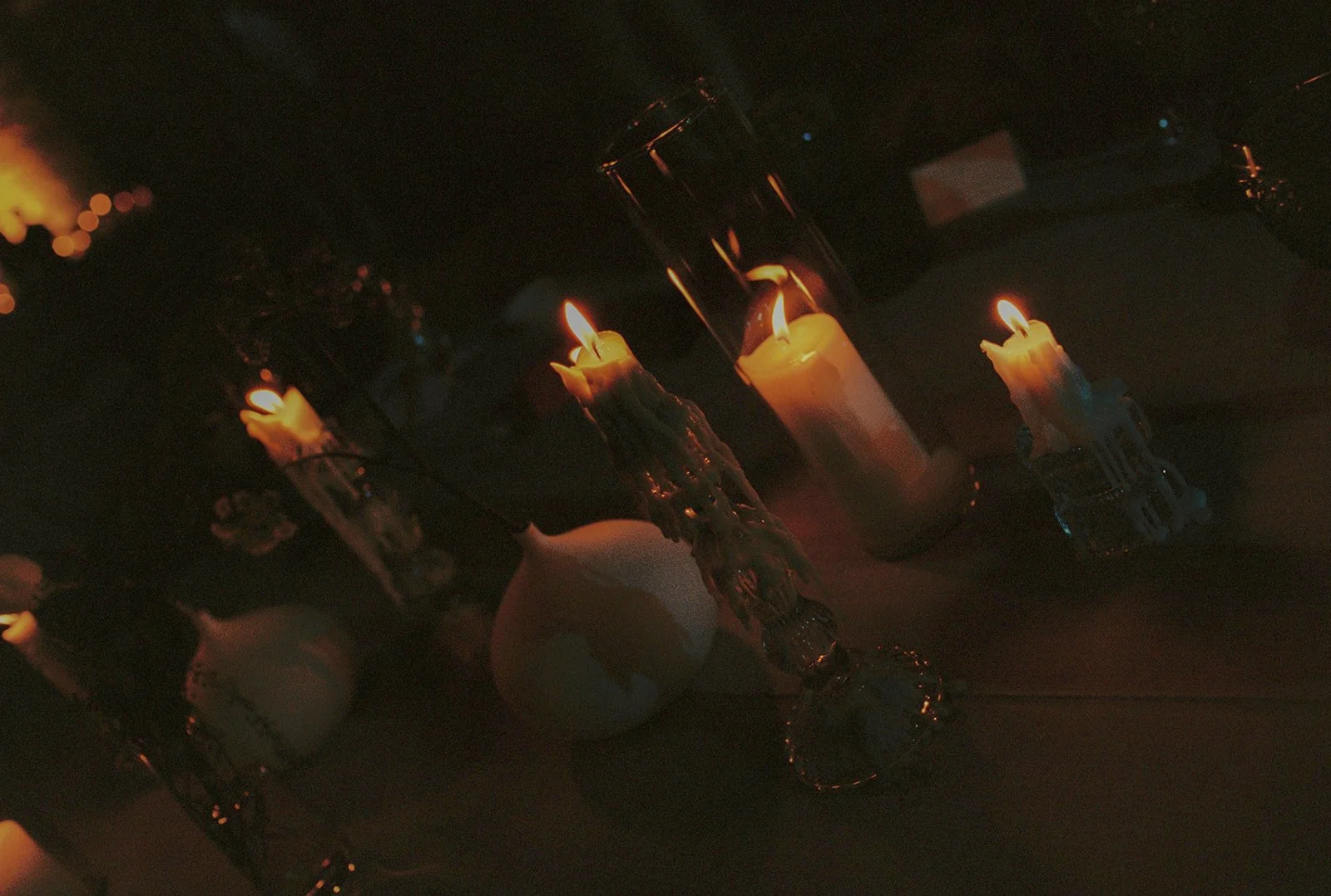 Film photo of a wedding dinner table at final in the after party moments with candles very melted