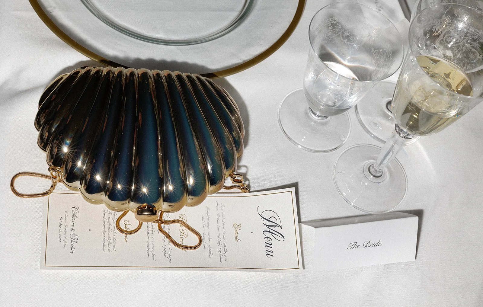 Flatlay at the dinner table of the bride's purse together with the food menu