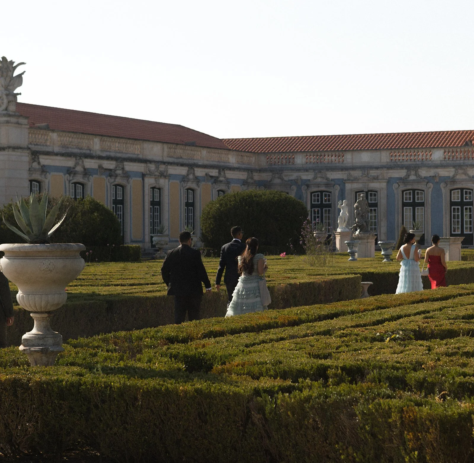 Guests in formal garden, Palácio de Queluz, wedding photography by The Lopes Photography, published in Vogue Arabia