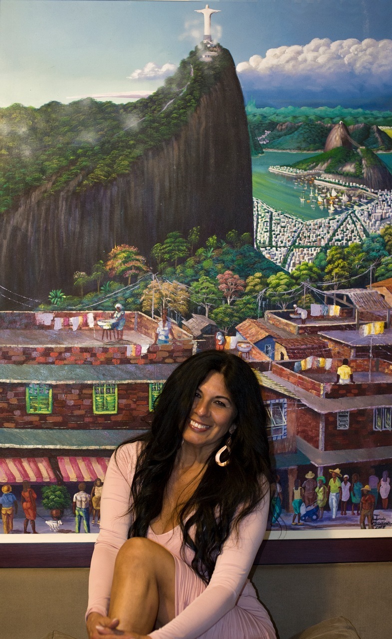 Elizabeth next to a painting showcasing Brazil.