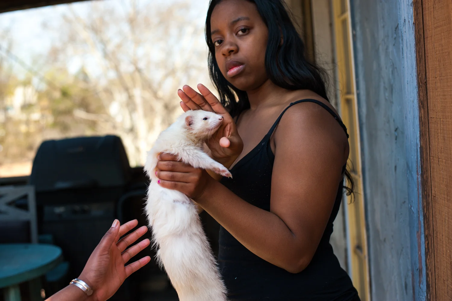   Stephanie Strasburg . April 18, 2015. Nizhae with her pet ferret outside her home in McKeesport, Allegheny County, Pennsylvania. 