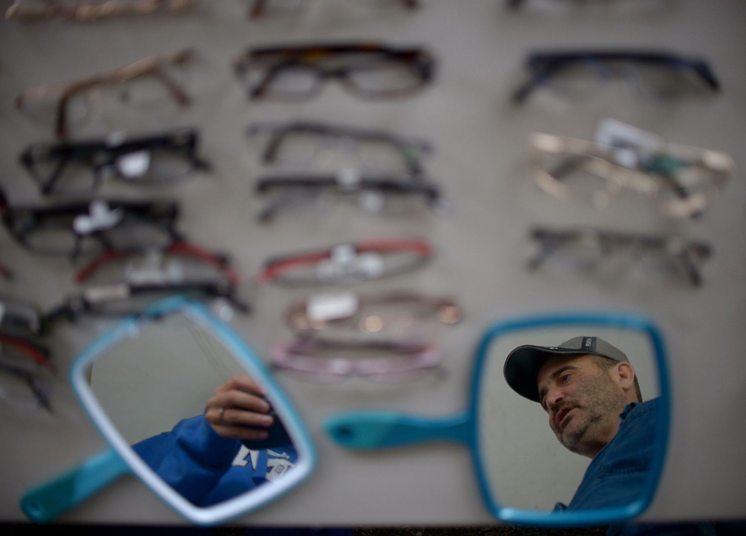 Pat Jarrett / The Virginia Folklife Program . July 19, 2014. Mitch Branham of Clintwood, Virginia picks out glasses at the vision tent. He said he loves to build things and has always worked in construction or mining. Wise, Wise County, Virginia.