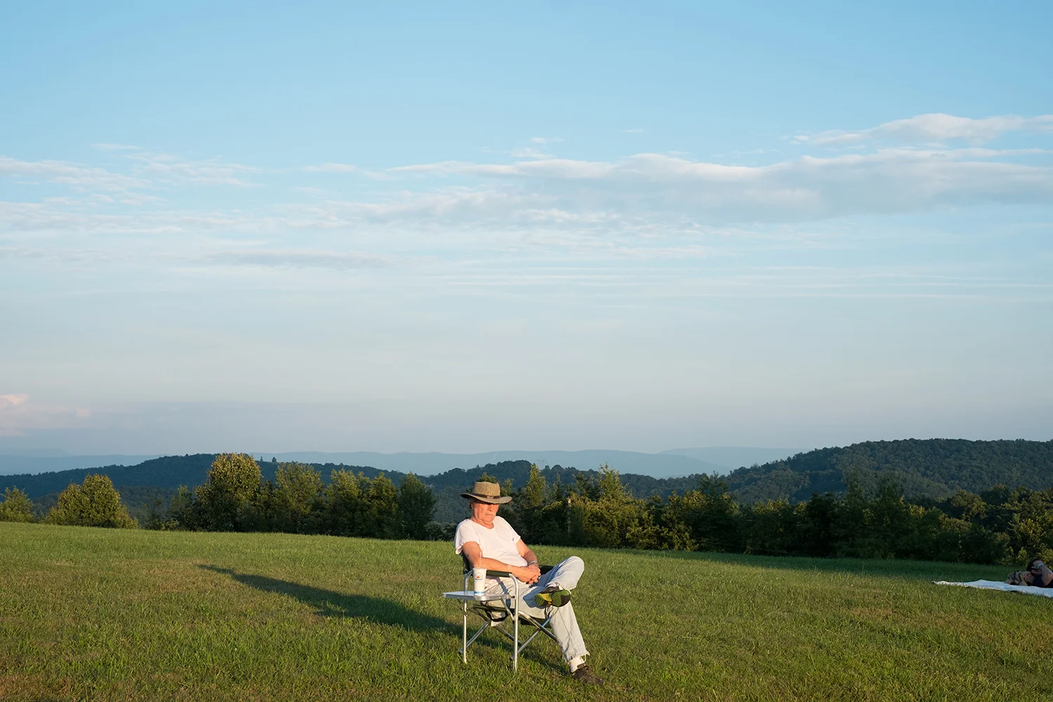 Roger May . July 17, 2015. A visitor listens to musical performance at the 50th anniversary celebration of the Appalachian South Folklife Center in Pipestem, Summers County, West Virginia.