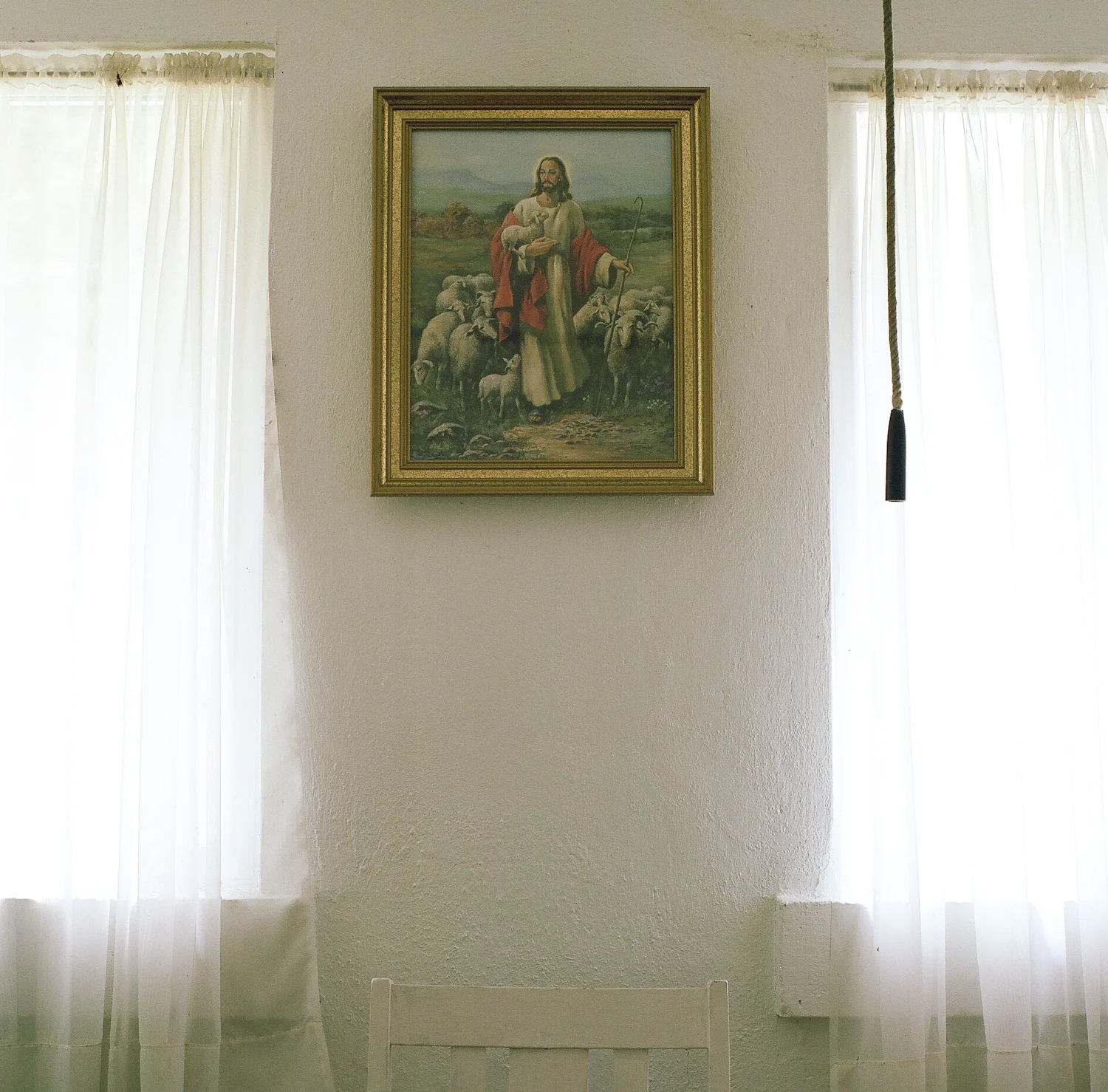 Alan Pittman. March 22, 2014. A portrait of Jesus hangs near the bell-tower rope in one of the classrooms at Valley Grove Methodist Church, Charleston, Kanawha County, West Virginia. Call and Response .