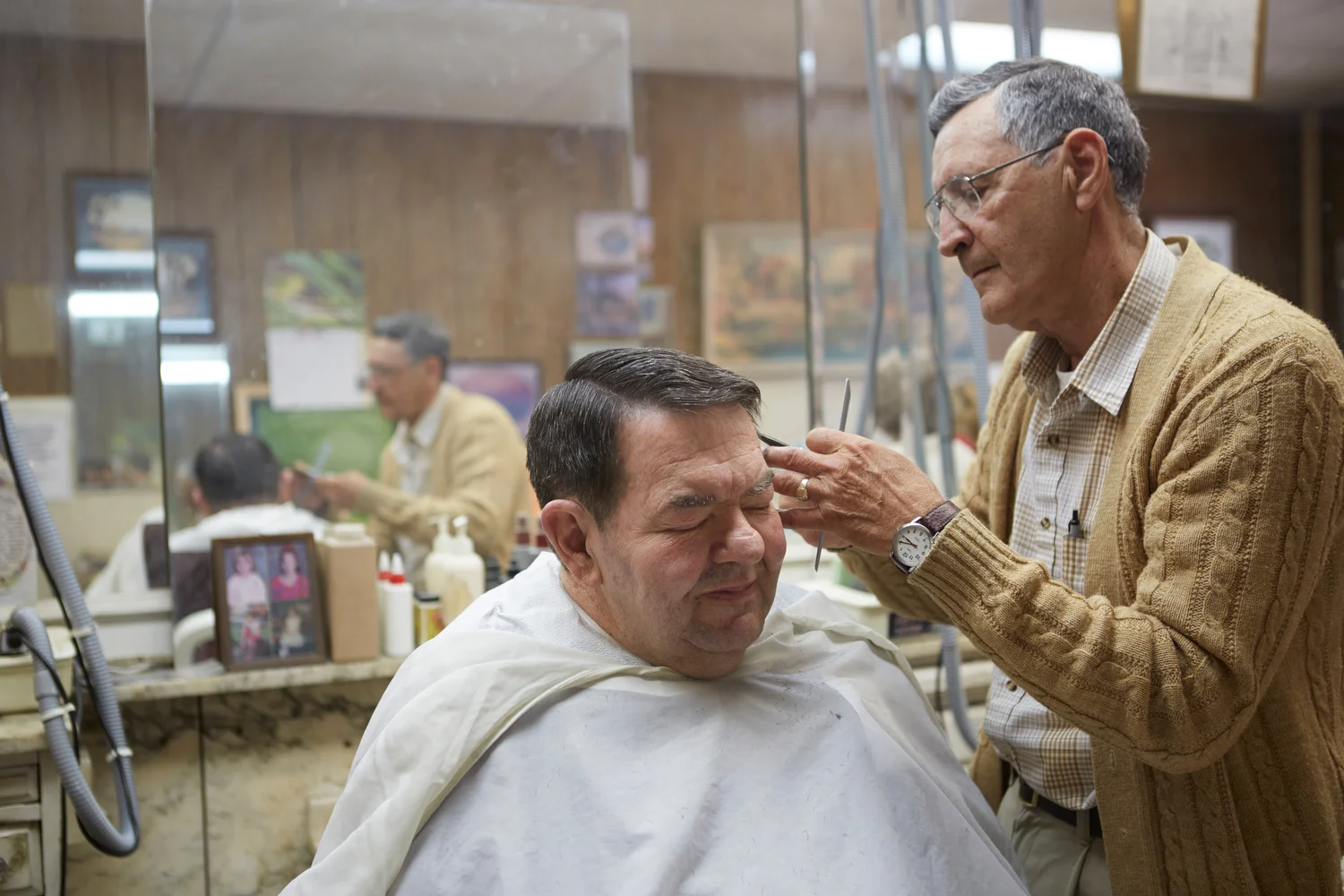  Ryan Stone . May 20, 2014. Ronald Sowder cuts Tom Fitzsimmons hair. Hinton, Summers County, West Virginia. 