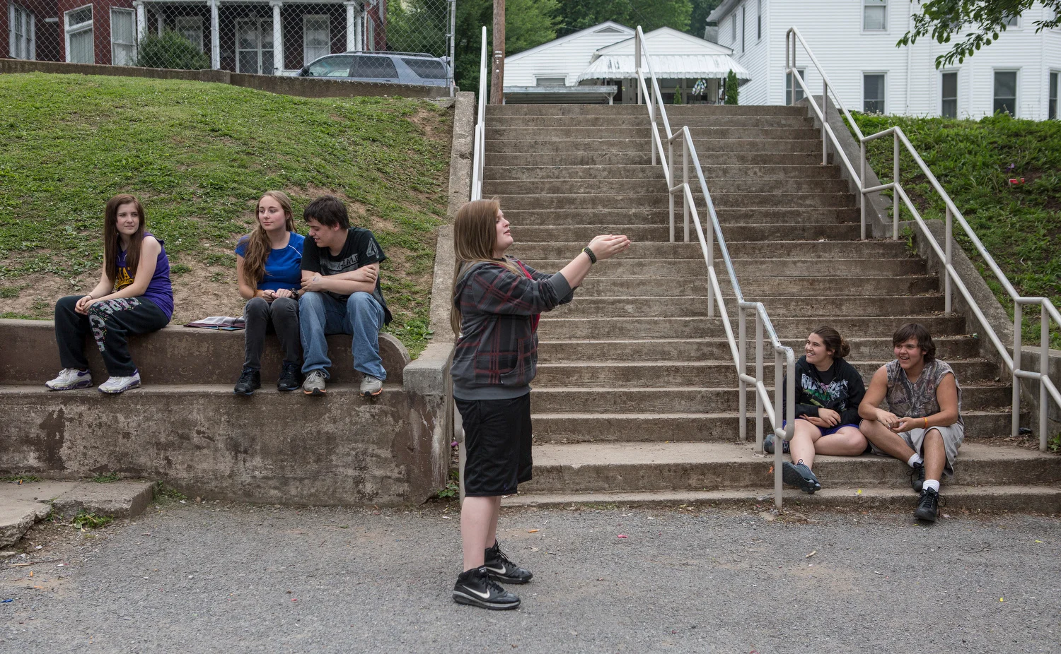   Ryan Stone . May 21, 2014. A group of students relax in the courtyard at Summers County Middle School, Hinton, West Virginia. 