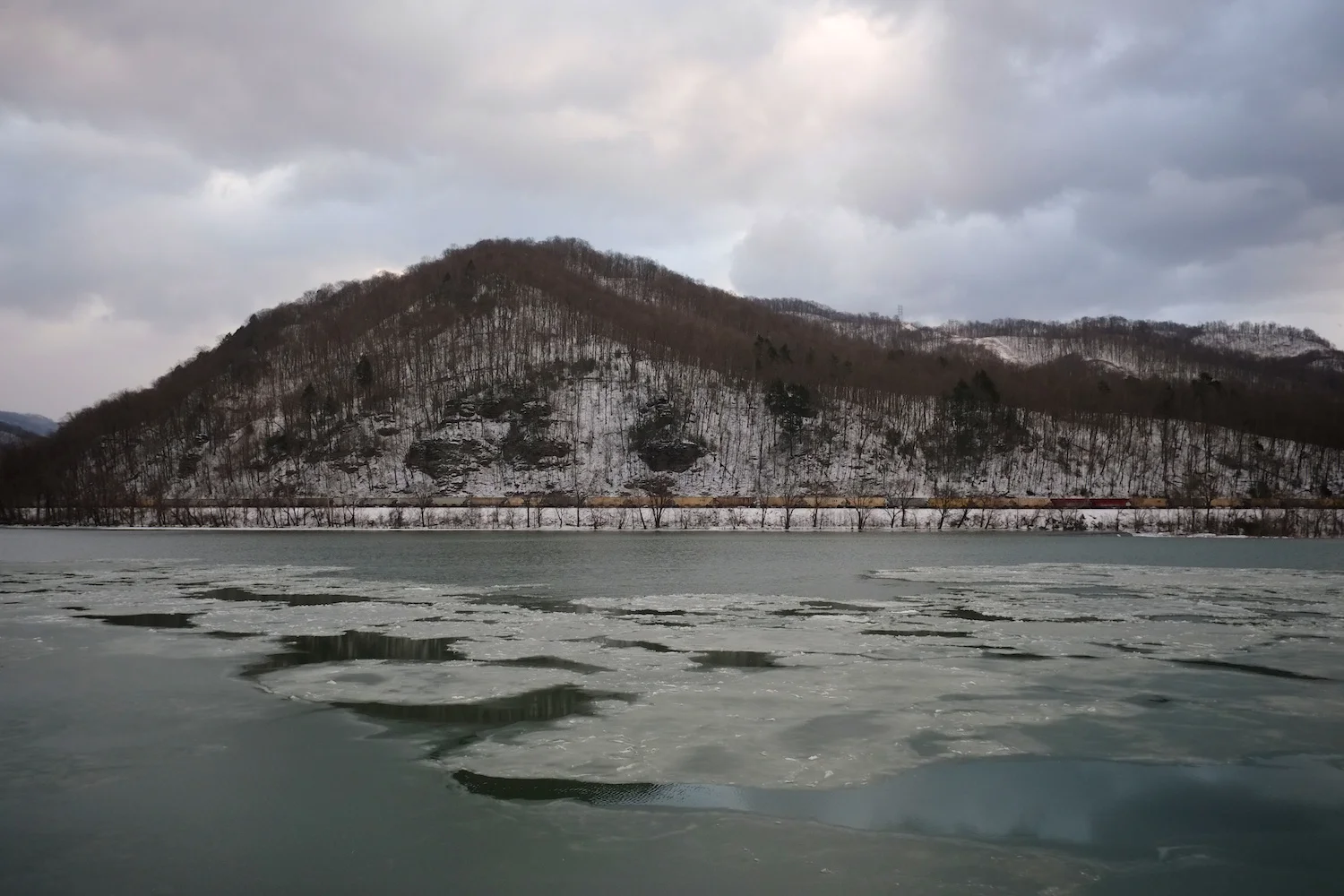 Roger May . January 25, 2014. Coal-laden railcars roll through the upper Kanawha Valley along the icy Kanawha River, just west of the confluence of the New and Gauley Rivers at Glen Ferris, Fayette County, West Virginia. (First published in The Guardian on January 30, 2014.)