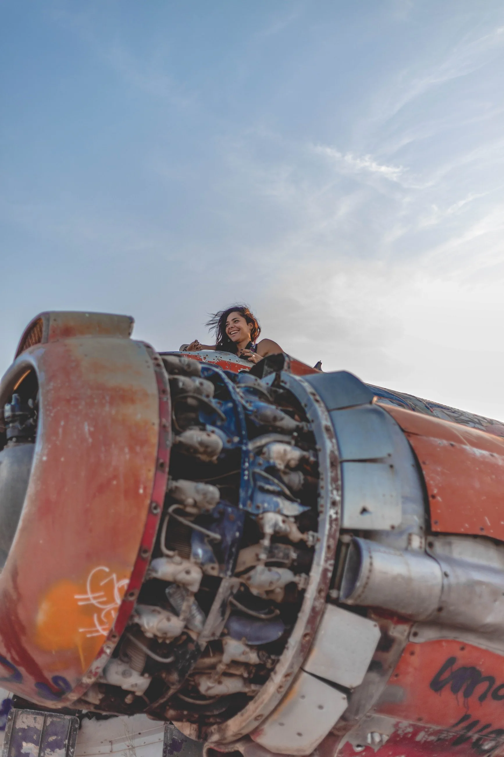 Creative portrait of a person posed atop large rusted industrial machinery, portrait photography by Everlux Photo Co.