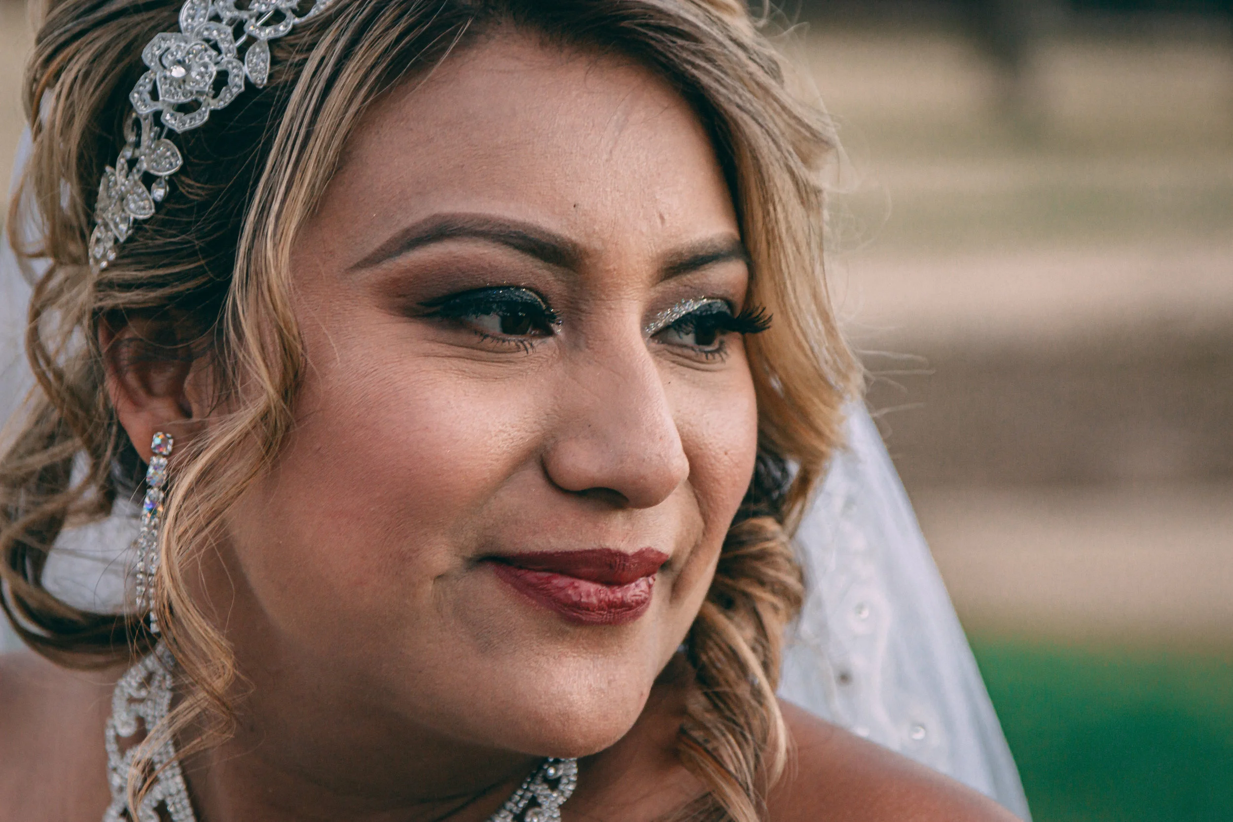 Close-up bridal portrait of a woman in a veil with bold makeup, wedding photography by Everlux Photo Co.