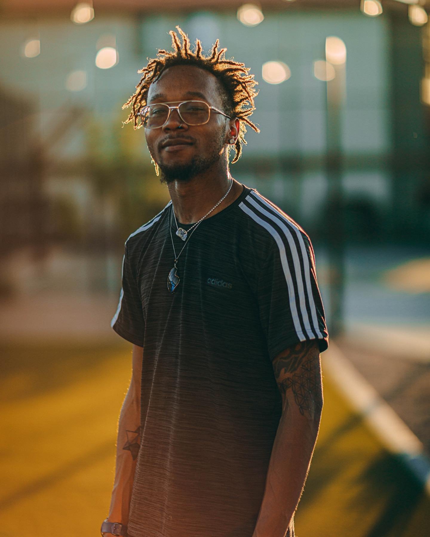 Portrait of a man with glasses at golden hour on an urban street, portrait photography by Everlux Photo Co.