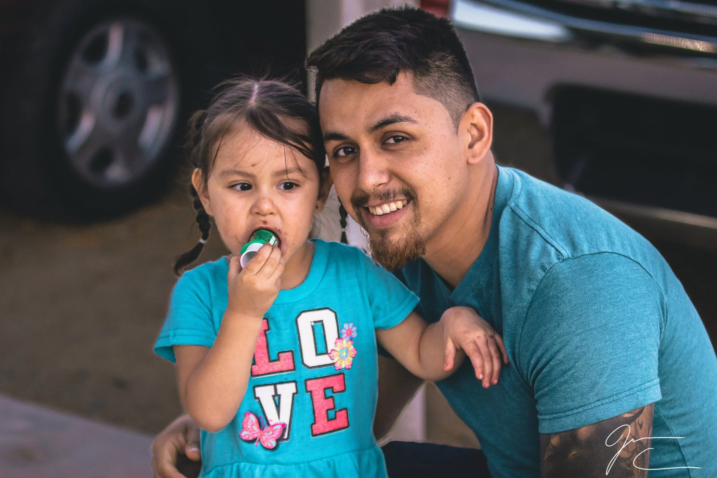 Candid family portrait of a man and a young girl smiling together, family photography by Everlux Photo Co.