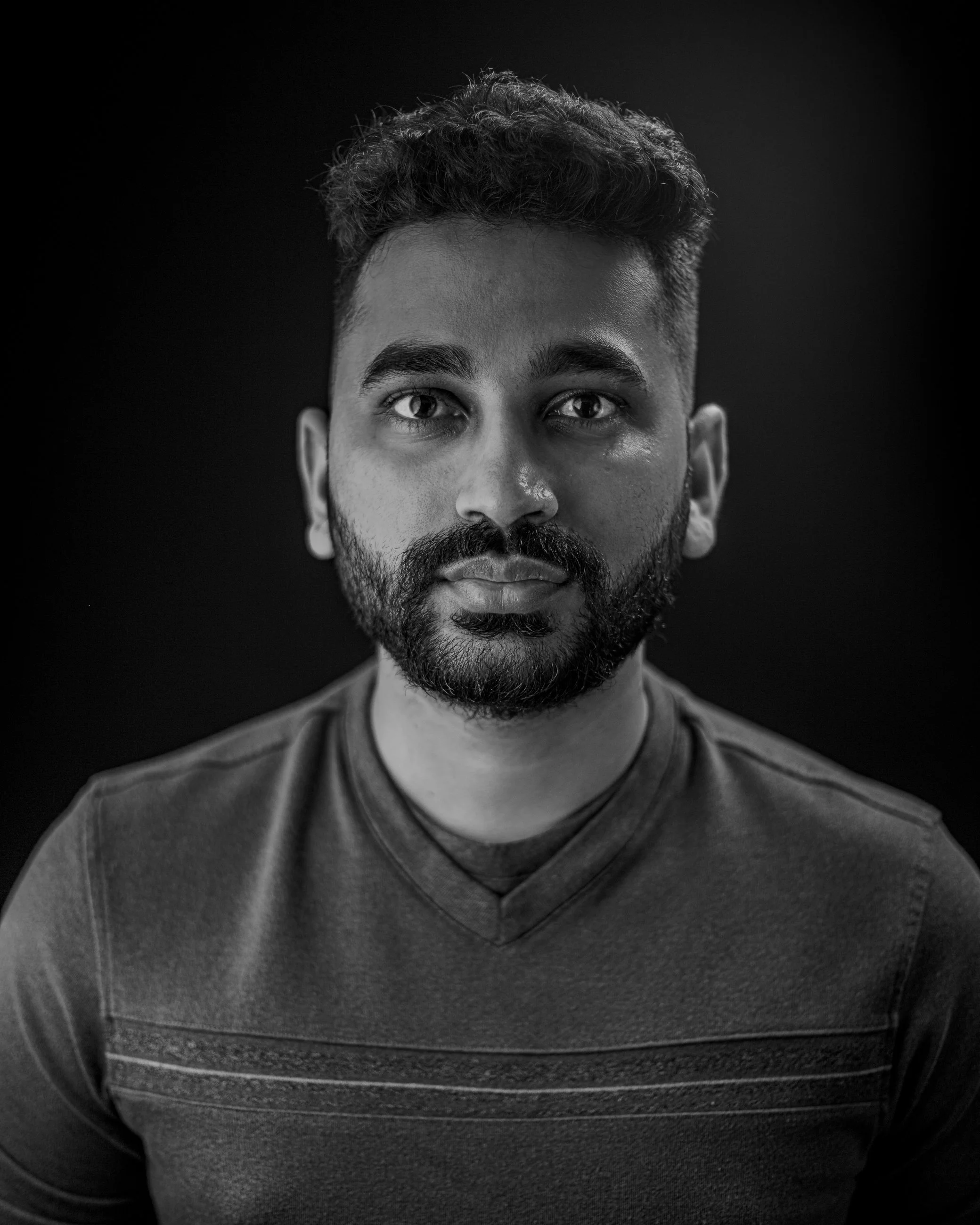 Black and white studio headshot of a man with a beard, portrait photography by Everlux Photo Co.