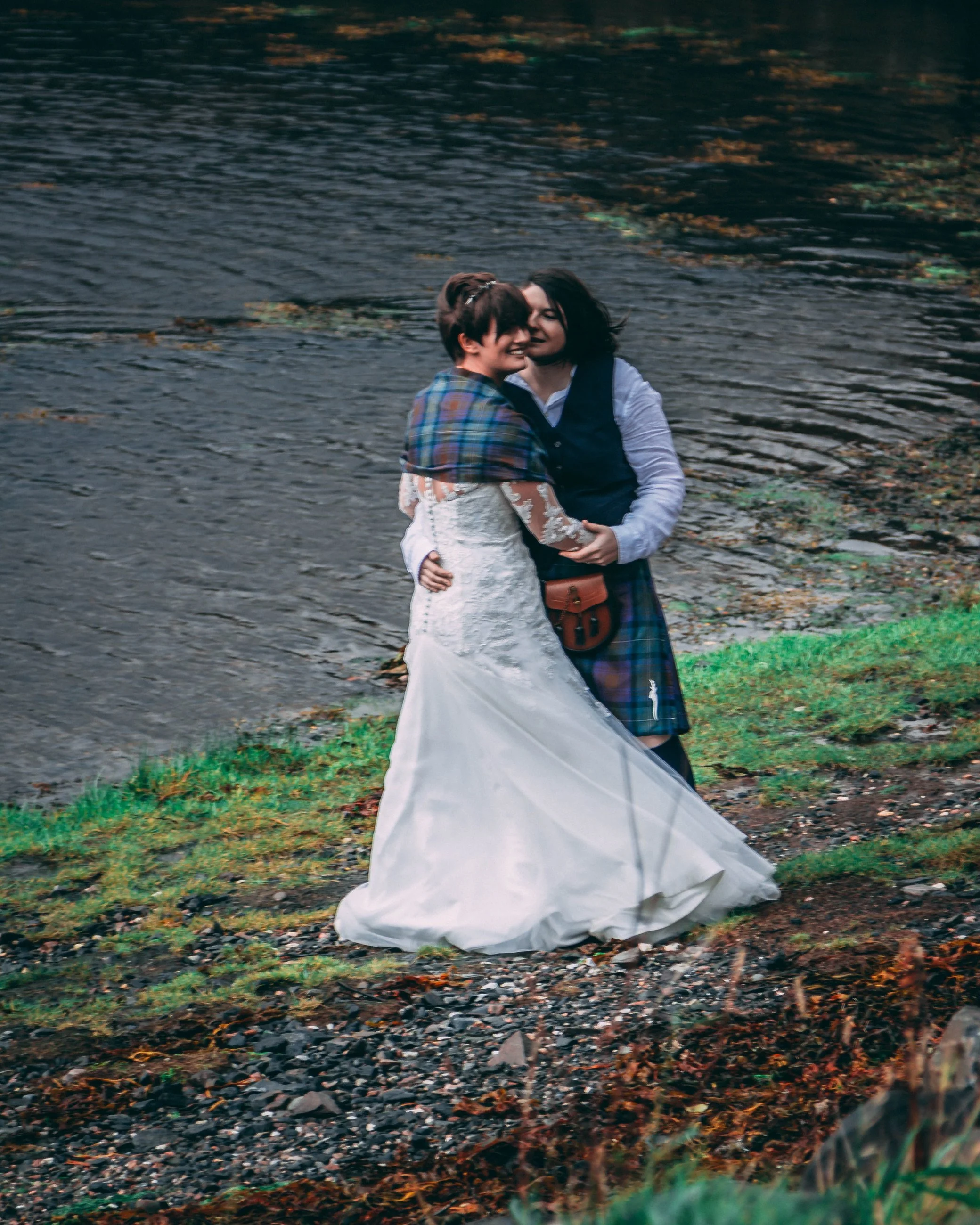 Portrait of a bride and groom walking together in a grassy field, wedding photography by Everlux Photo Co.