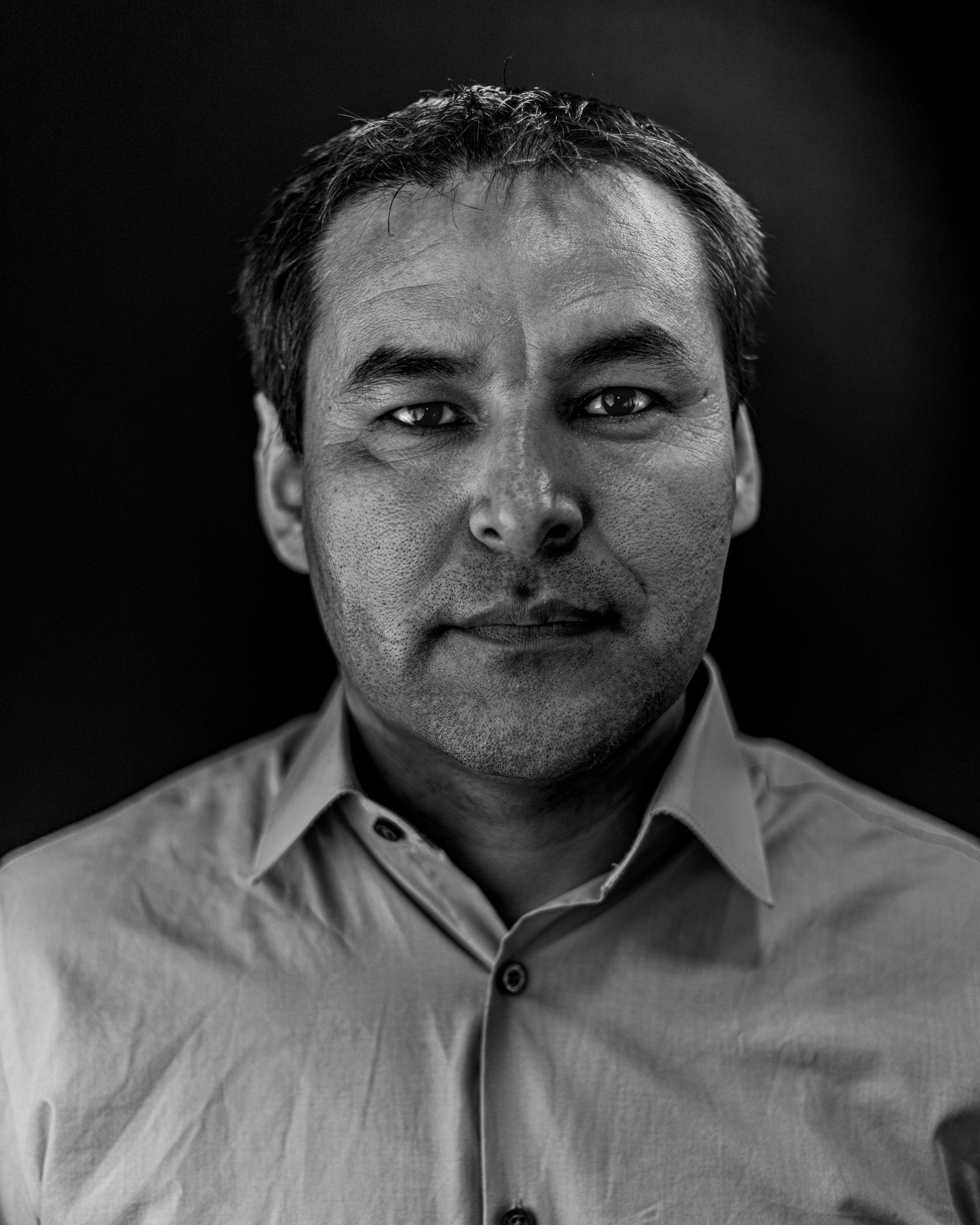 Black and white studio portrait of a man, portrait photography by Everlux Photo Co.