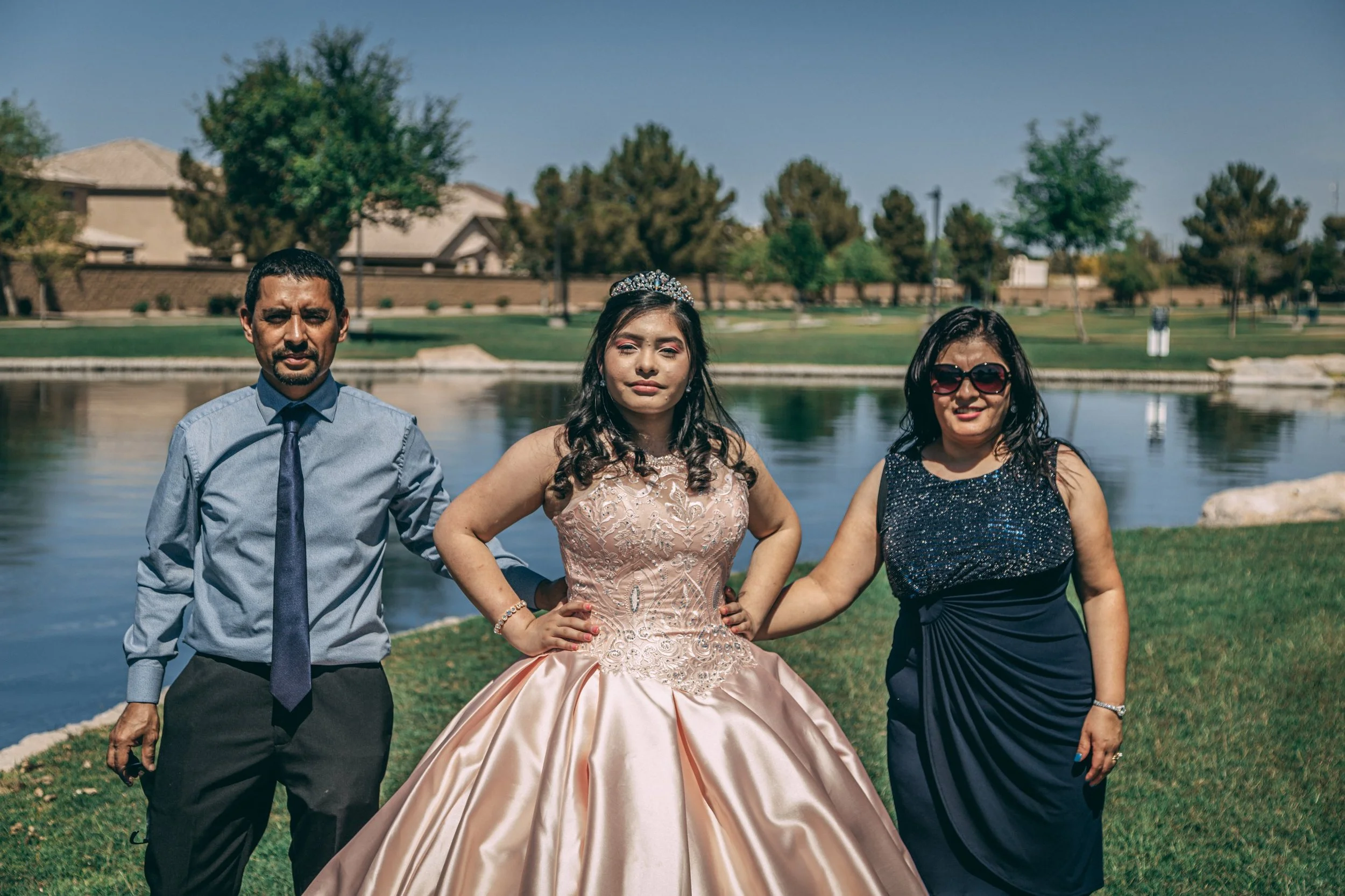Group portrait of three formally dressed people beside a pond at sunset, celebration portrait photography by Everlux Photo Co.