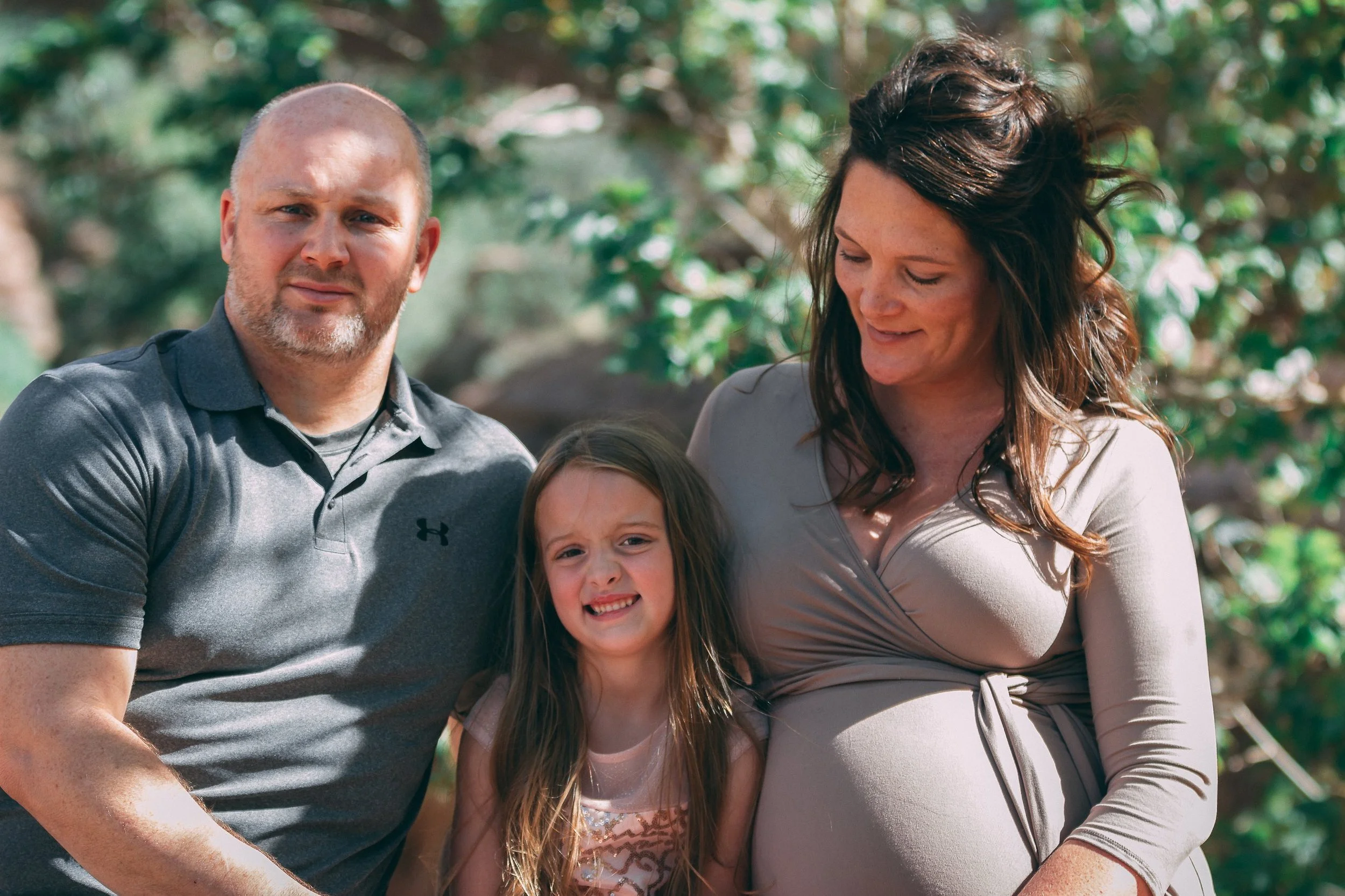 Outdoor family portrait of parents with their young daughter, maternity family photography by Everlux Photo Co.