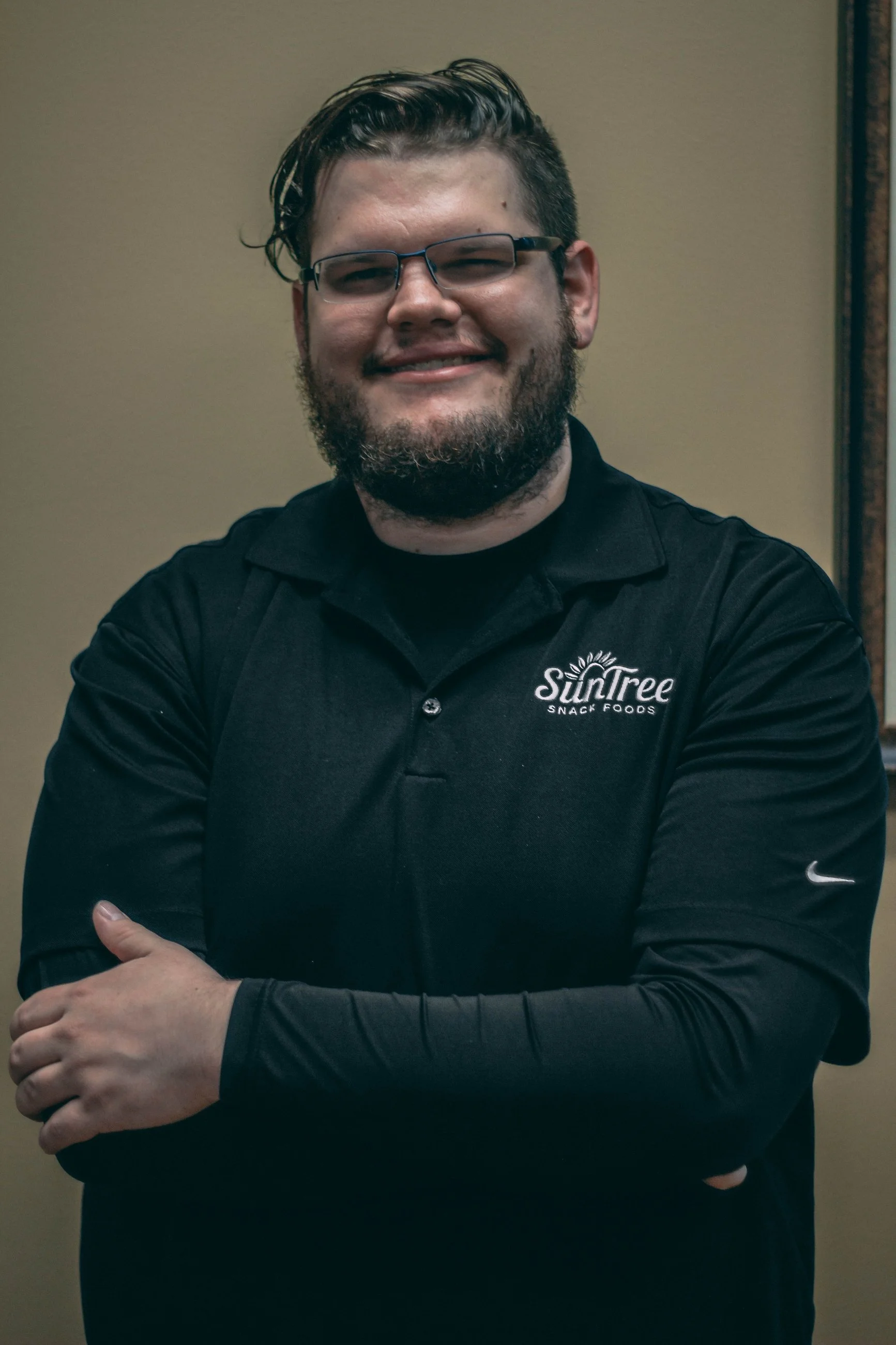 Professional headshot of a man in a branded jacket with arms crossed, business headshot photography by Everlux Photo Co.