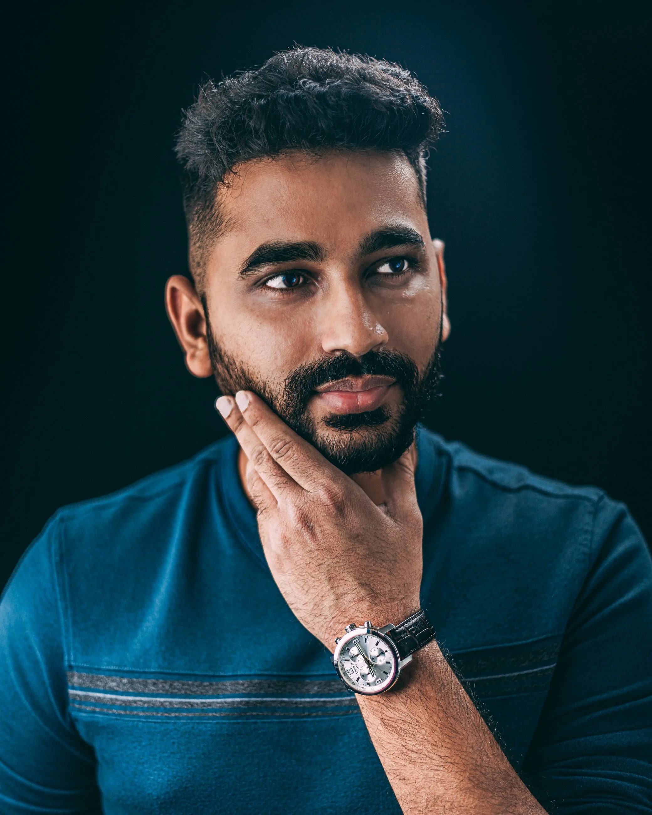 Studio portrait of a man touching his beard, portrait photography by Everlux Photo Co.