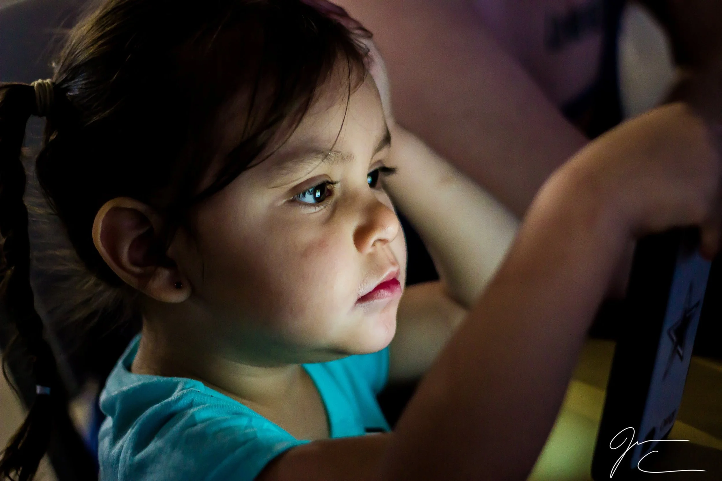 Candid close-up portrait of a young child looking off camera, child photography by Everlux Photo Co.