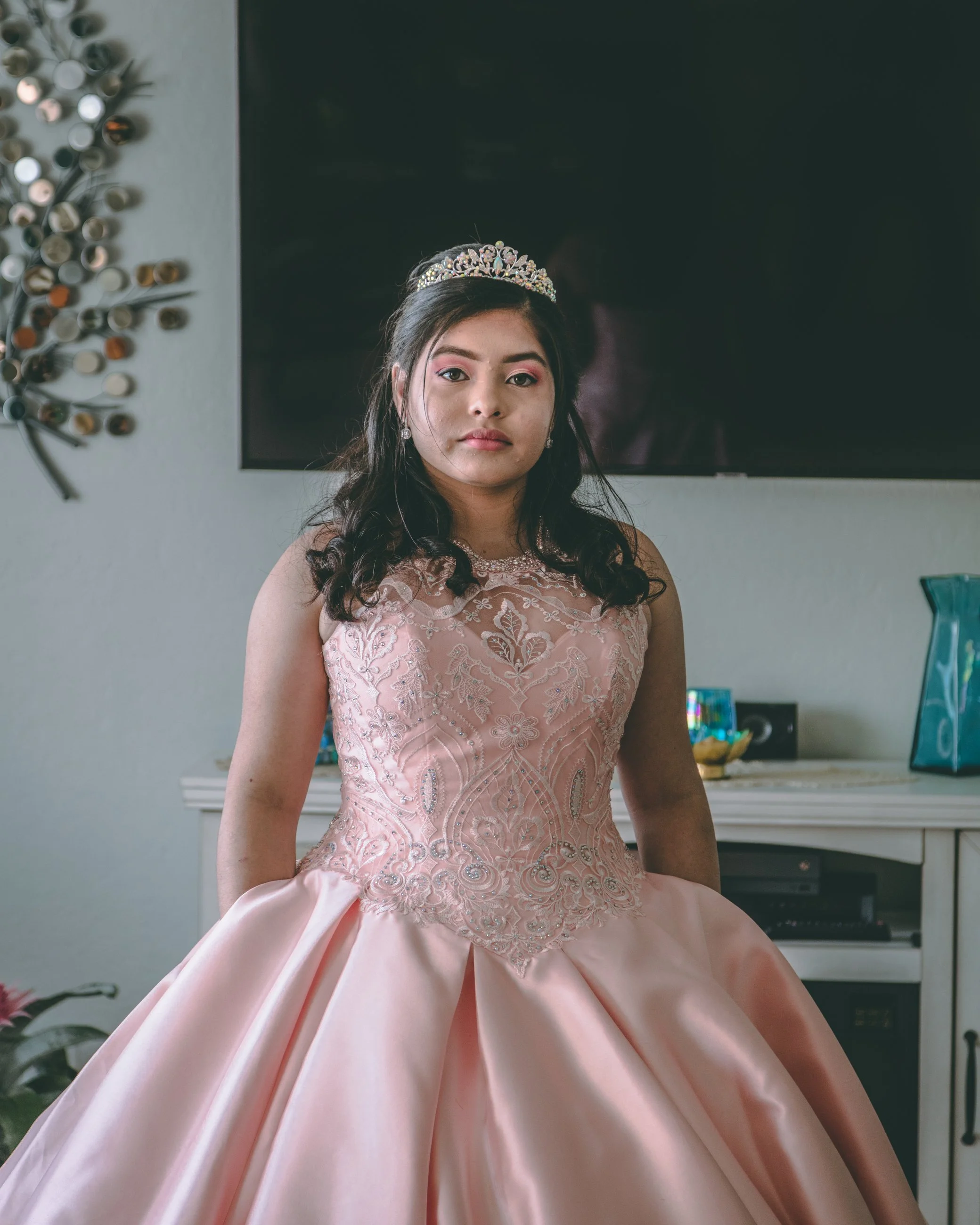 Portrait of a young woman in an elegant pink quinceañera gown and tiara, celebration portrait photography by Everlux Photo Co.