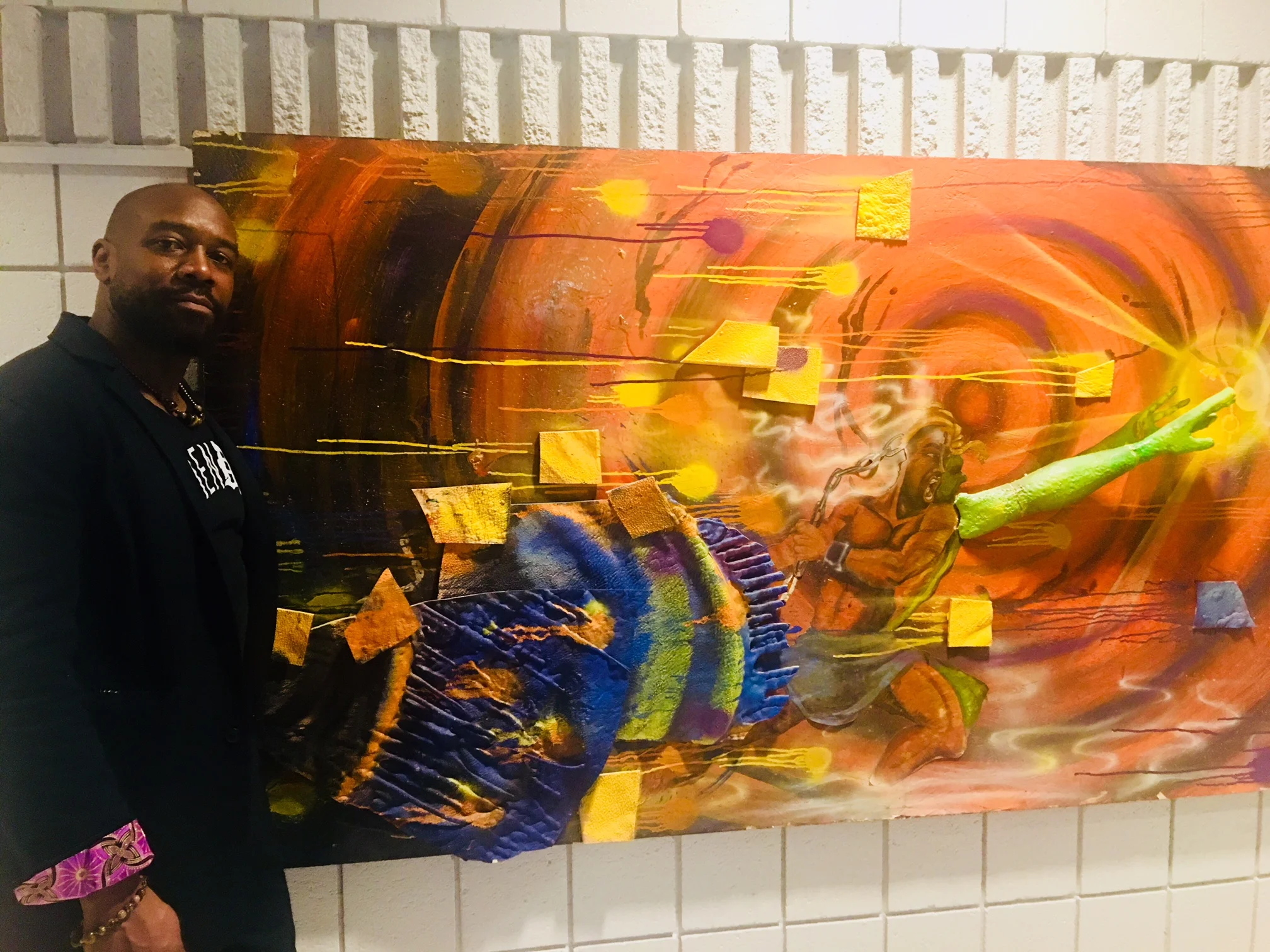 Artist Nivek Monet with his multi-media canvas “Transcendence”