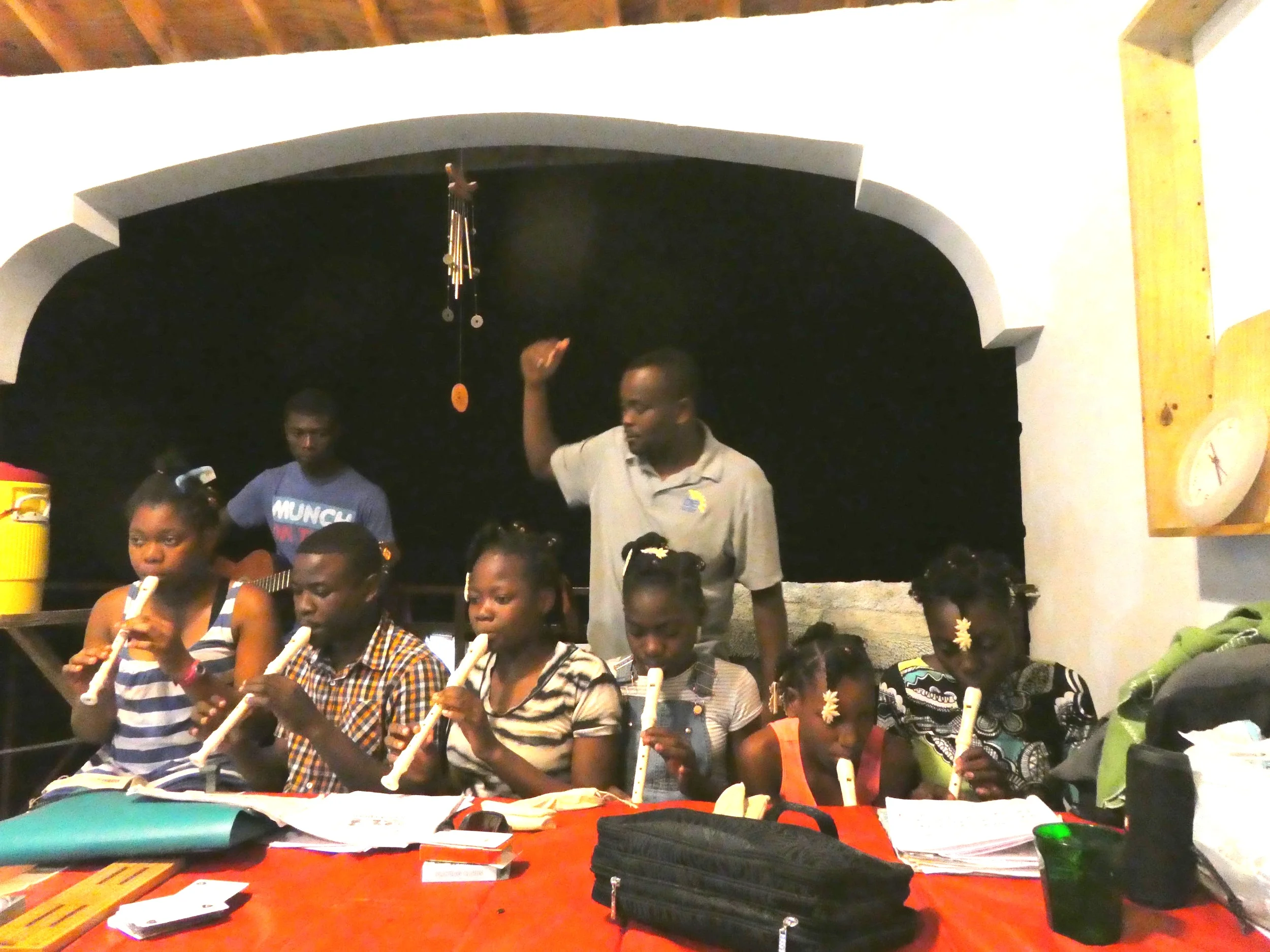 Feed My Lambs Students in Haiti playing their newly donated recorders under the direction of Mr. Kelly.