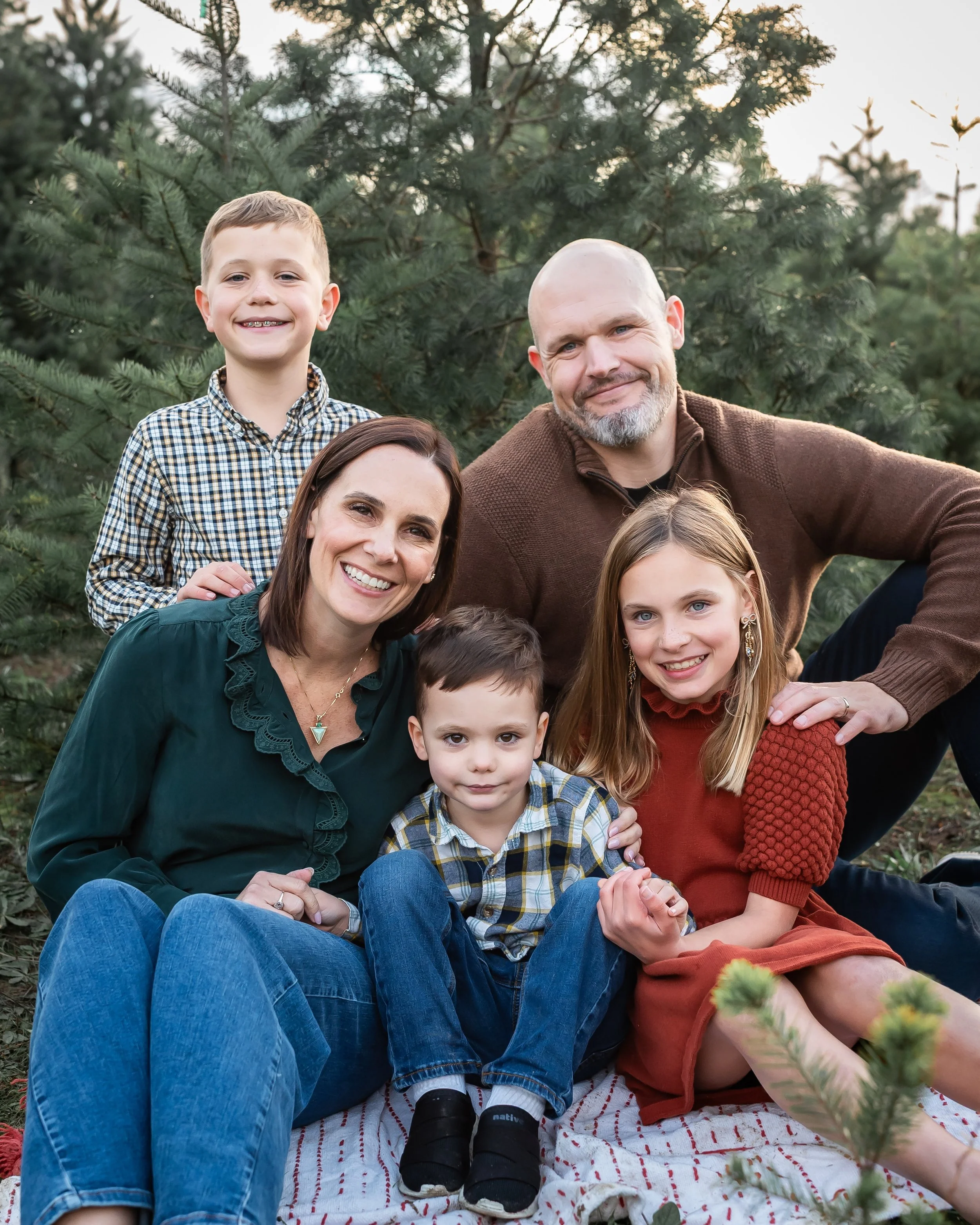 Family of five smiling together during a relaxed outdoor family photography session in Sonoma County.