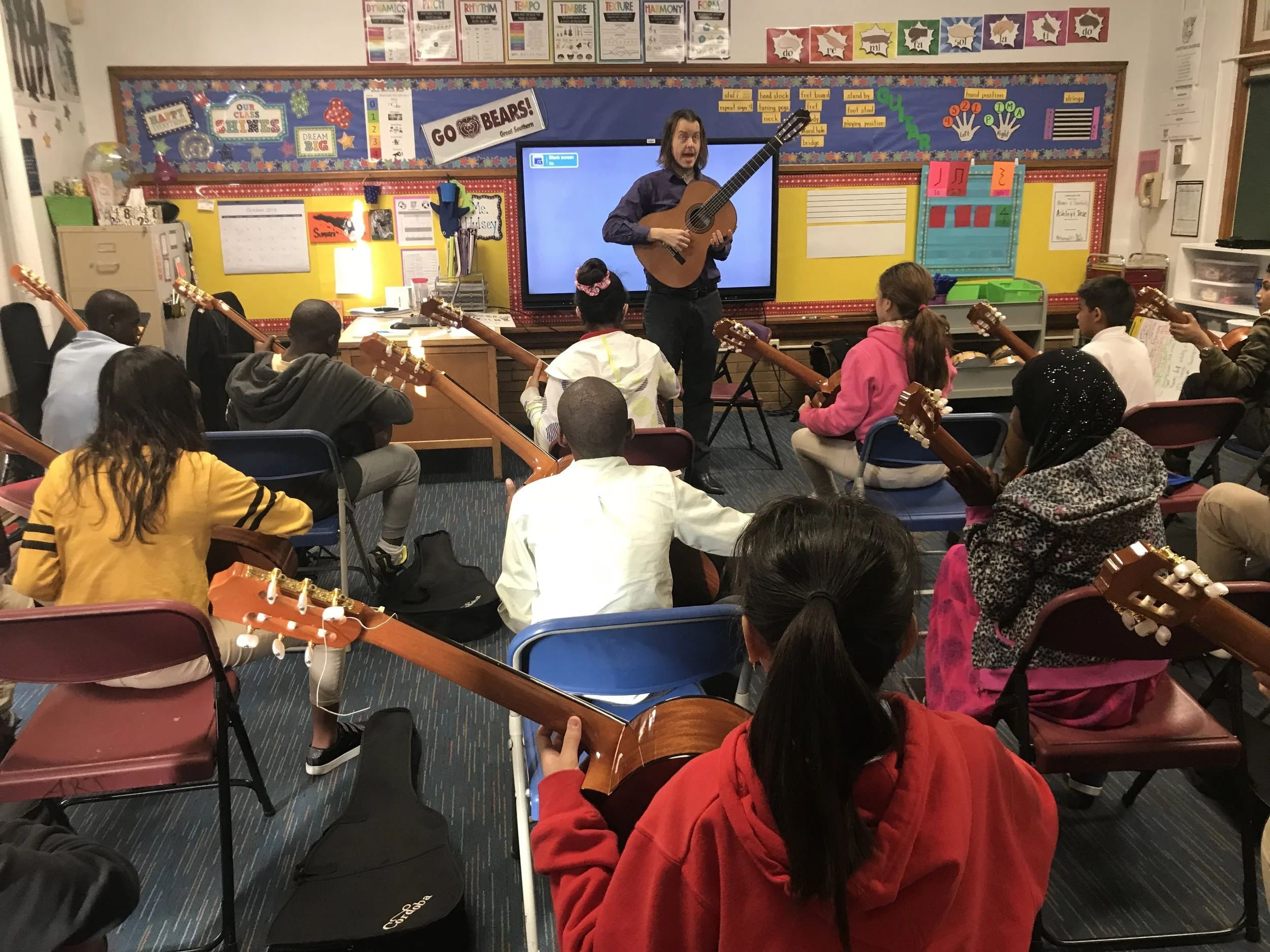 SLCG Teaching Artist, Mark Akin, working with students at Nahed Chapman New American Academy