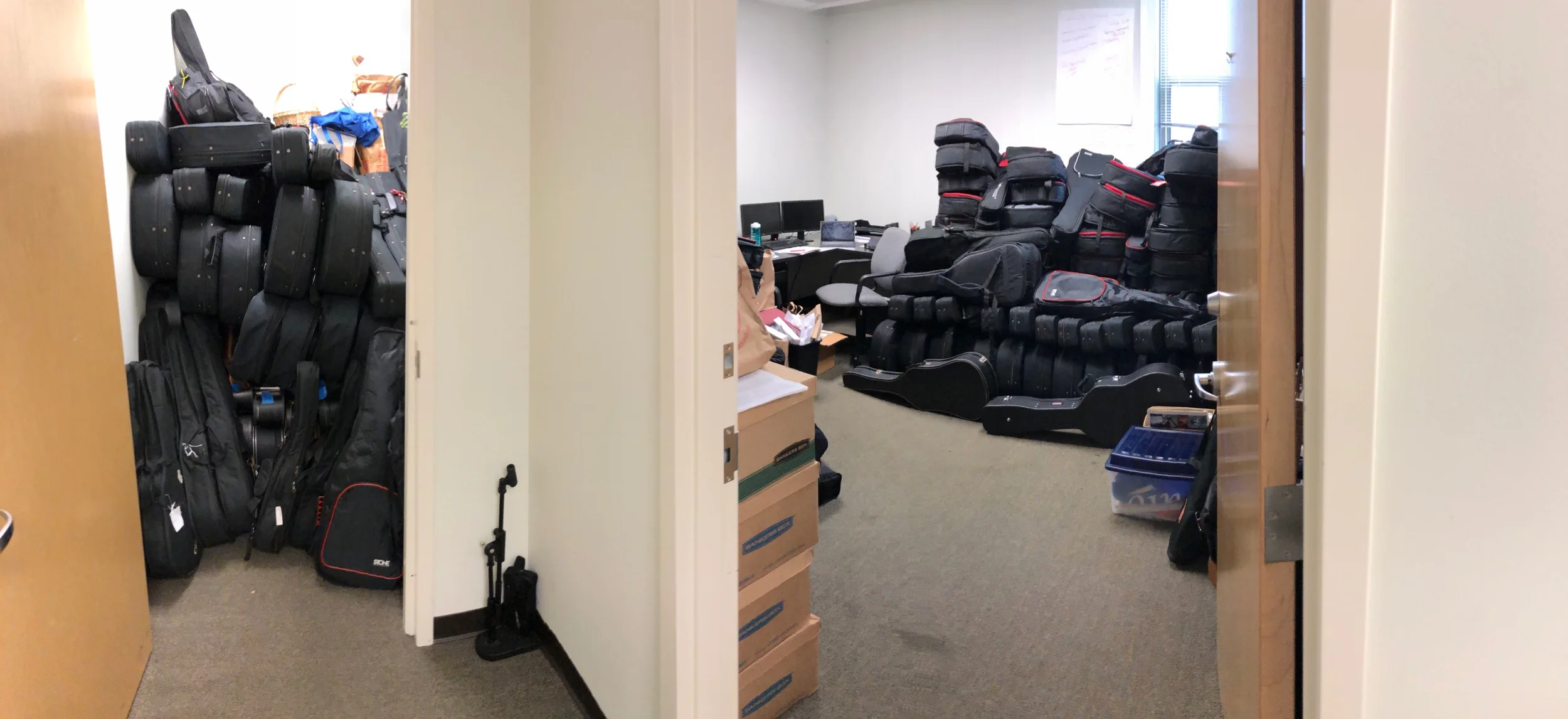 Two piles of guitars in our office at the Centene Center for the Arts