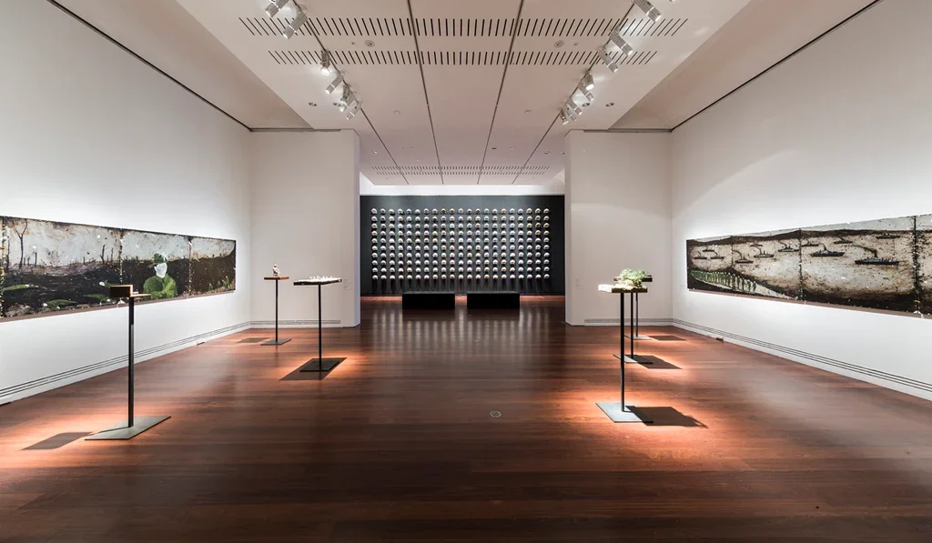  Installation view:  Spatial Operations  behind Richard Lewer's work  The rotting bodies of men drowning in mud, the sweet stench of our death, my life is given ,  Sappers &amp; Shrapnel: Contemporary Art and the Art of the Trenches,  curated by Lisa