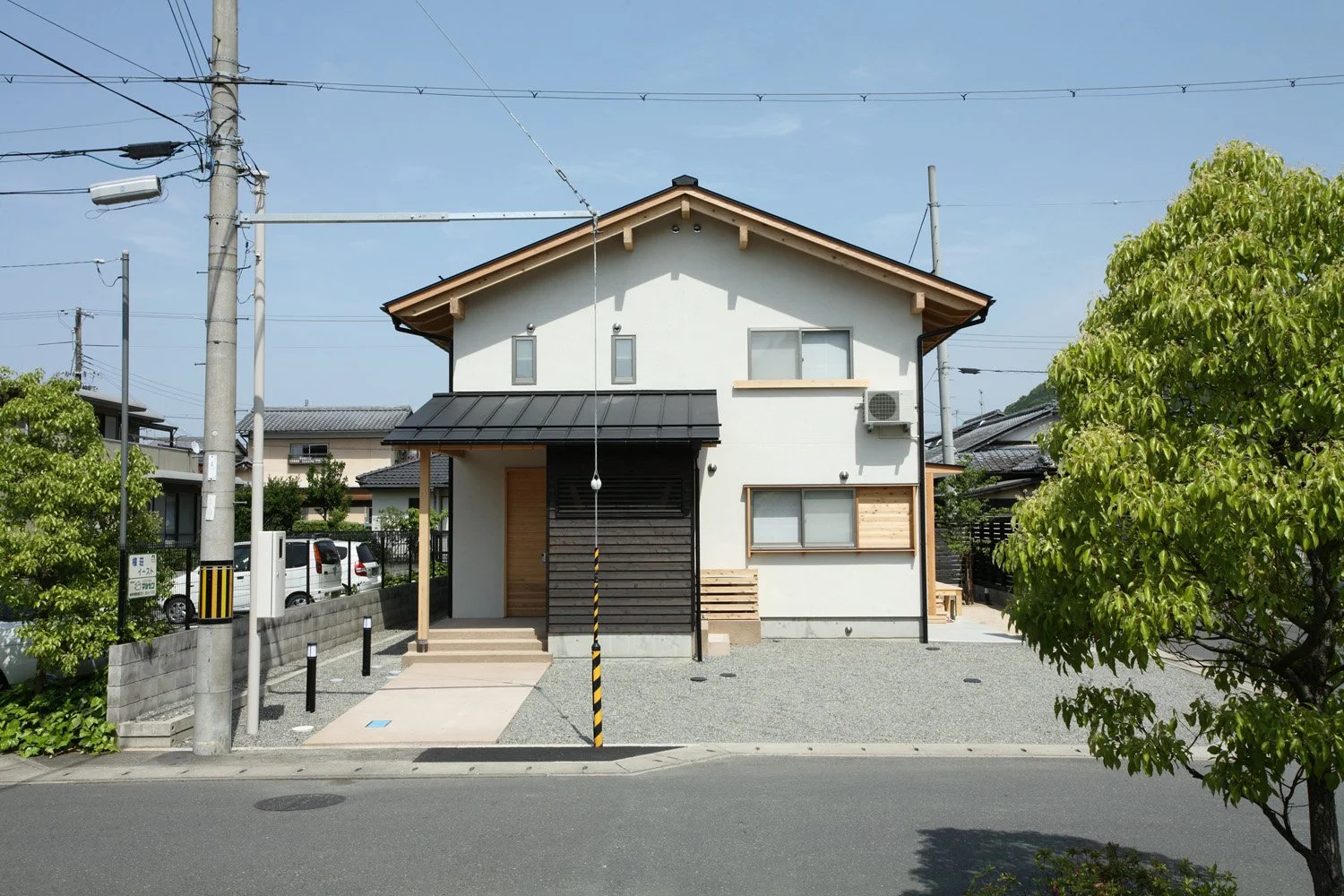 白い外壁の切妻屋根の2階建ての家