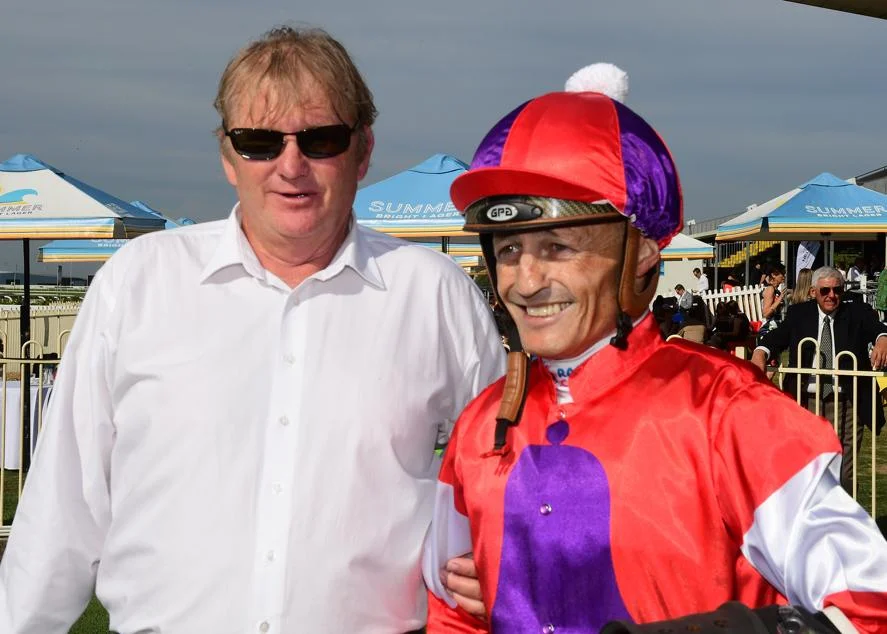 Trainer Kelly Schweida and jockey Damien Browne after Oink's win at Doomben. Image provided by News Limited. 