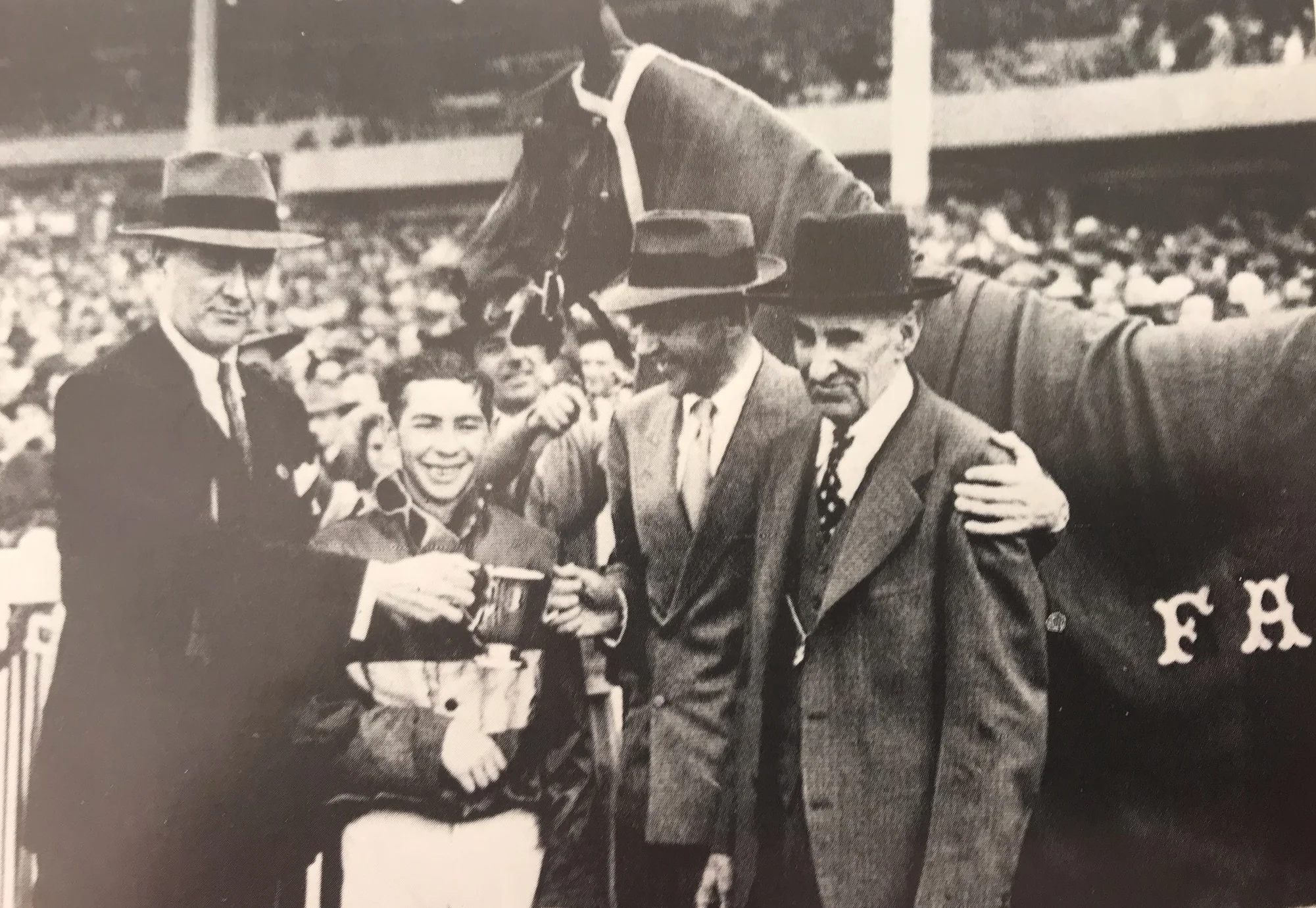 Fred Astaire with an arm around trainer Clyde Phillips after San Juan Capistrano Handicap at Santa Anita 1946.