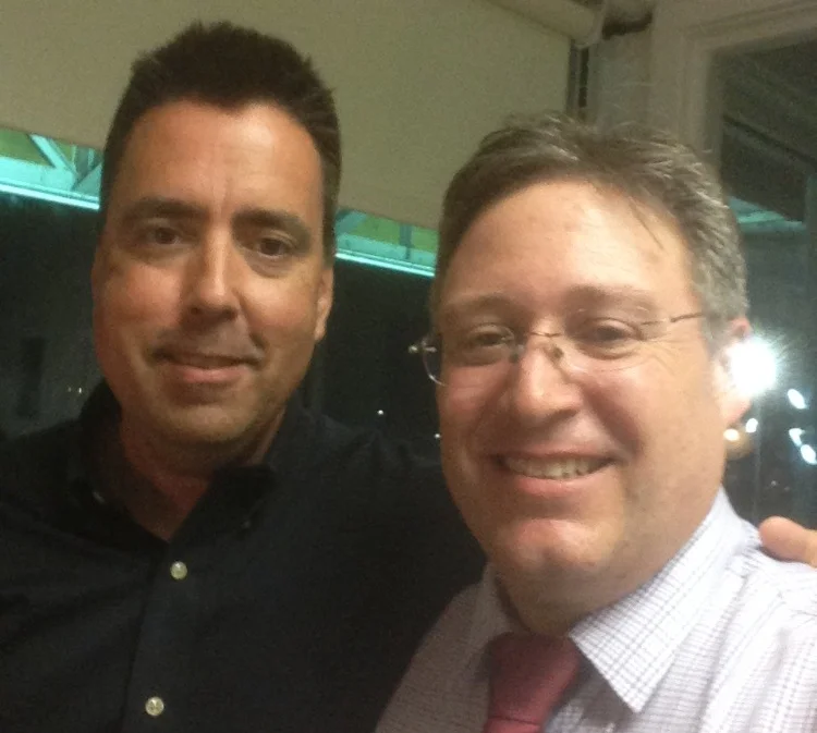 Fred got to call three races at Yonkers during a holiday trip. Here he is in the box with USA caller John Hernan.