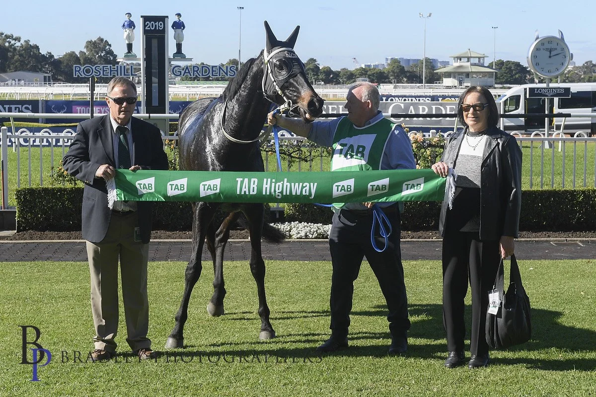 Image courtesy Bradley Photographers - Norm and Diane with the winner's sash at Rosehill Gardens.