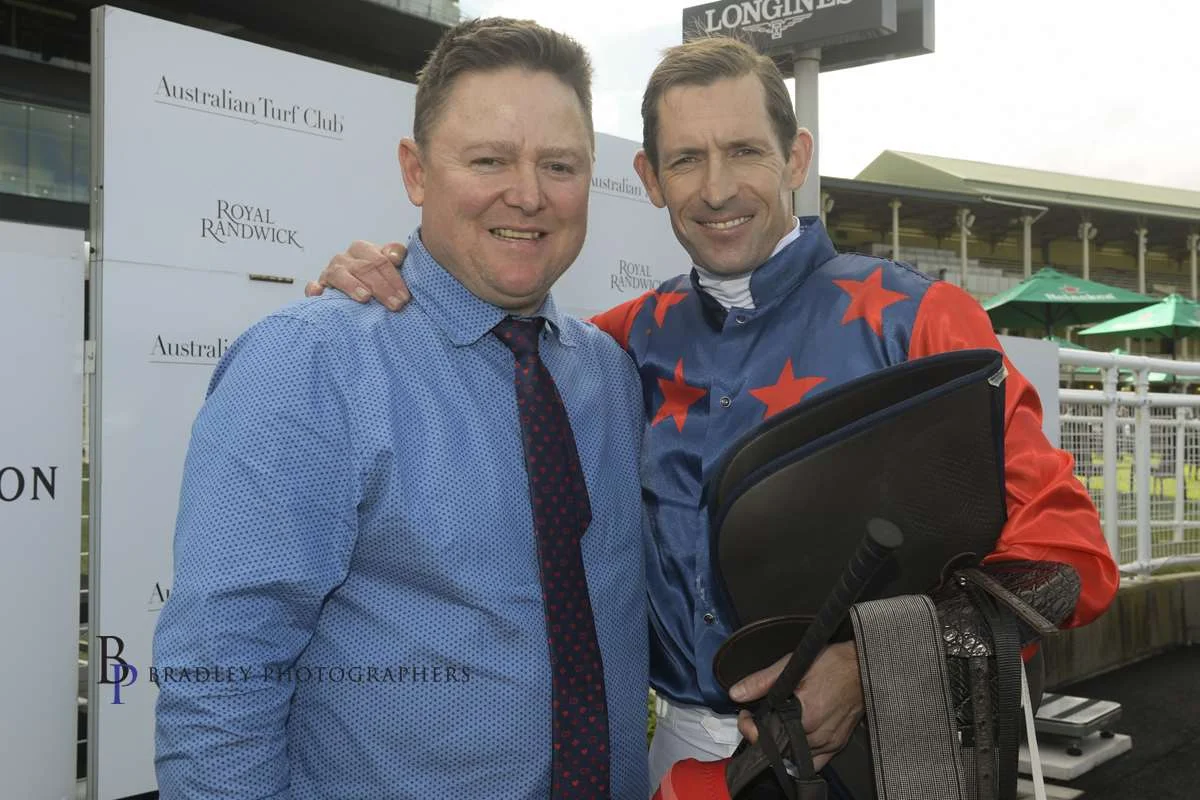 Image courtesy Bradley Photographers - Adam Duggan with Hugh Bowman after Sir Elton's impressive Randwick win 06/07/2019.