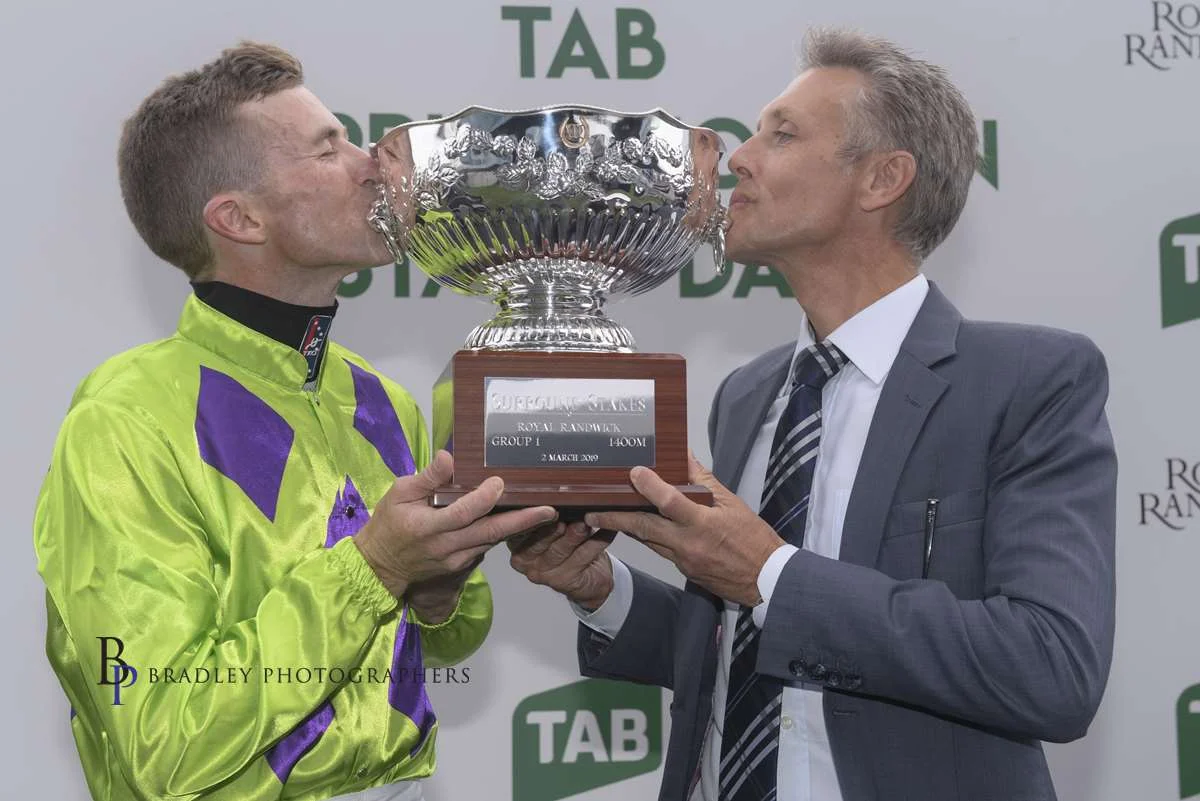 Image courtesy Bradley Photographers - How sweet it is! Mark and Josh Parr celebrate a Group 1 Surround Stakes win with Nakeeta Jane.